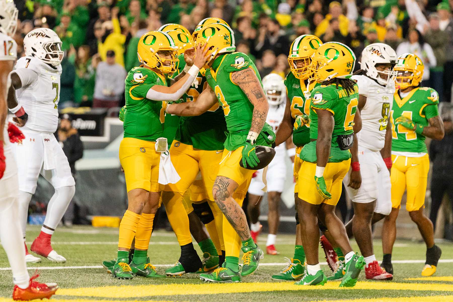 EUGENE, OREGON - NOVEMBER 9:  Quarterback Dillon Gabriel #8 reacts after a touchdown by tight end Terrance Ferguson #3 of the Oregon Ducks at the end of the first half of the game against the Maryland Terrapins at Autzen Stadium on November 9, 2024 in Eugene, Oregon.  (Photo by Ali Gradischer/Getty Images)
