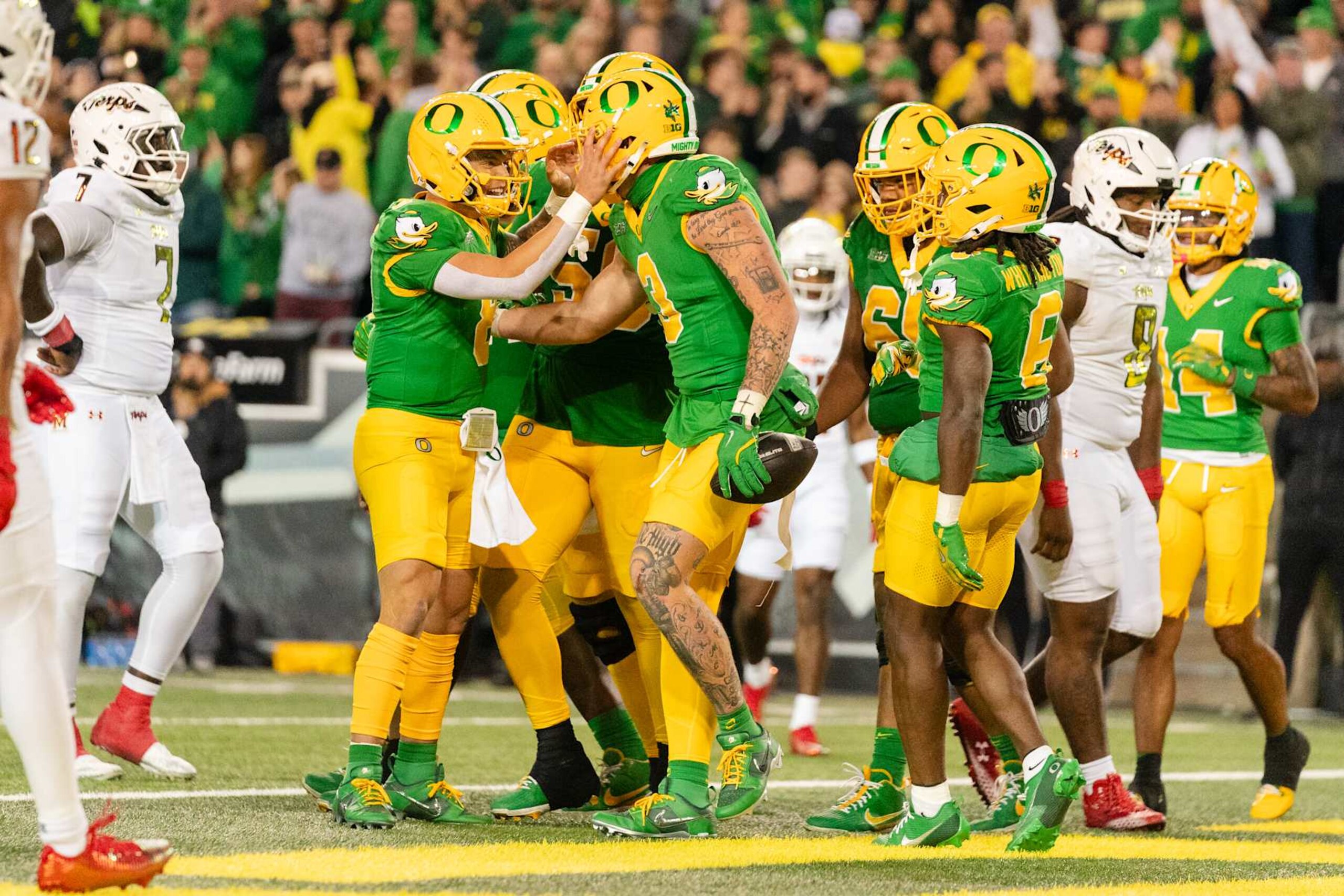 EUGENE, OREGON - NOVEMBER 9:  Quarterback Dillon Gabriel #8 reacts after a touchdown by tight end Terrance Ferguson #3 of the Oregon Ducks at the end of the first half of the game against the Maryland Terrapins at Autzen Stadium on November 9, 2024 in Eugene, Oregon.  (Photo by Ali Gradischer/Getty Images)