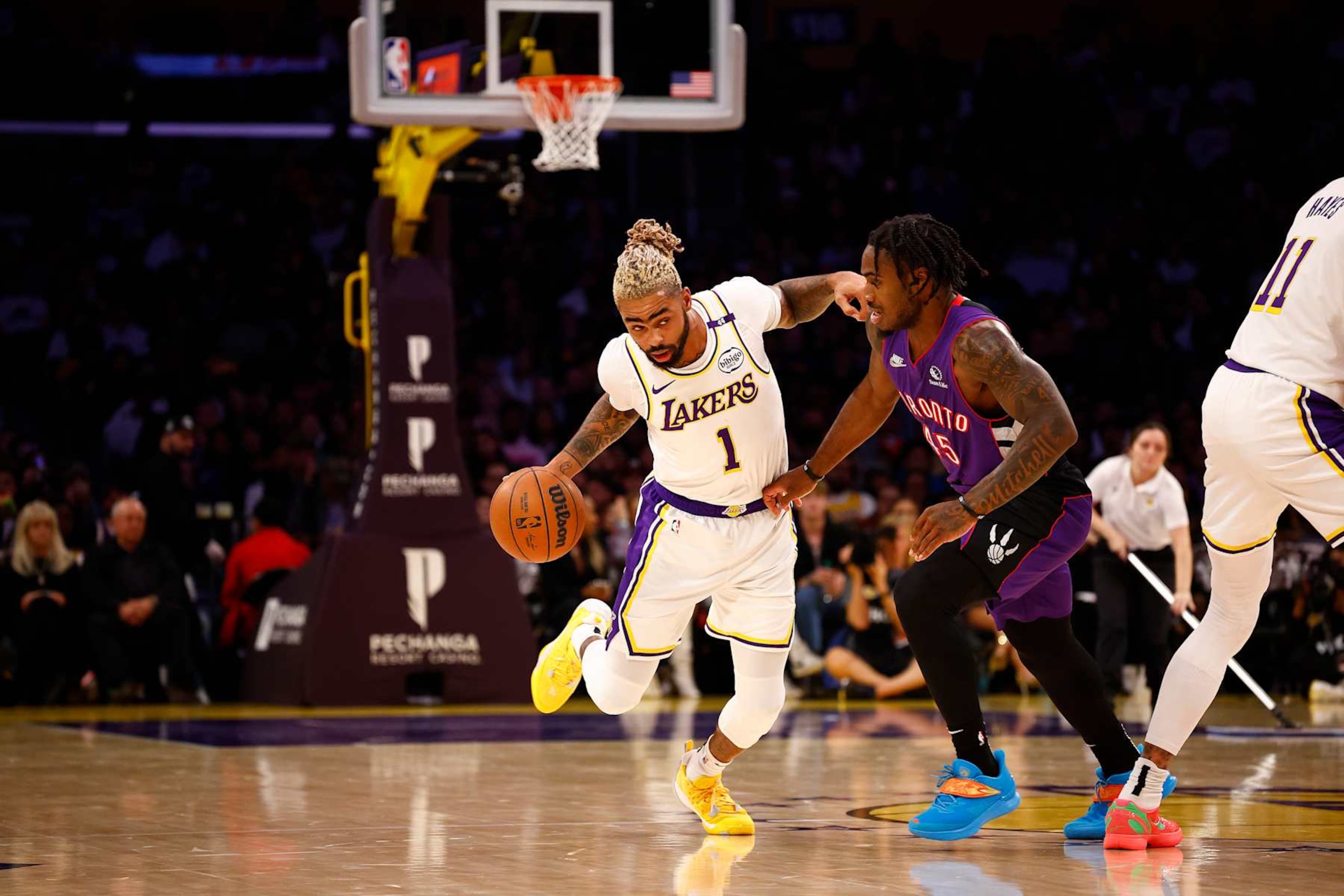 LOS ANGELES, CALIFORNIA - NOVEMBER 10:  D'Angelo Russell #1 of the Los Angeles Lakers controls the ball against Davion Mitchell #45 of the Toronto Raptors in the first half at Crypto.com Arena on November 10, 2024 in Los Angeles, California.  NOTE TO USER: User expressly acknowledges and agrees that, by downloading and/or using this photograph, user is consenting to the terms and conditions of the Getty Images License Agreement. (Photo by Ronald Martinez/Getty Images)