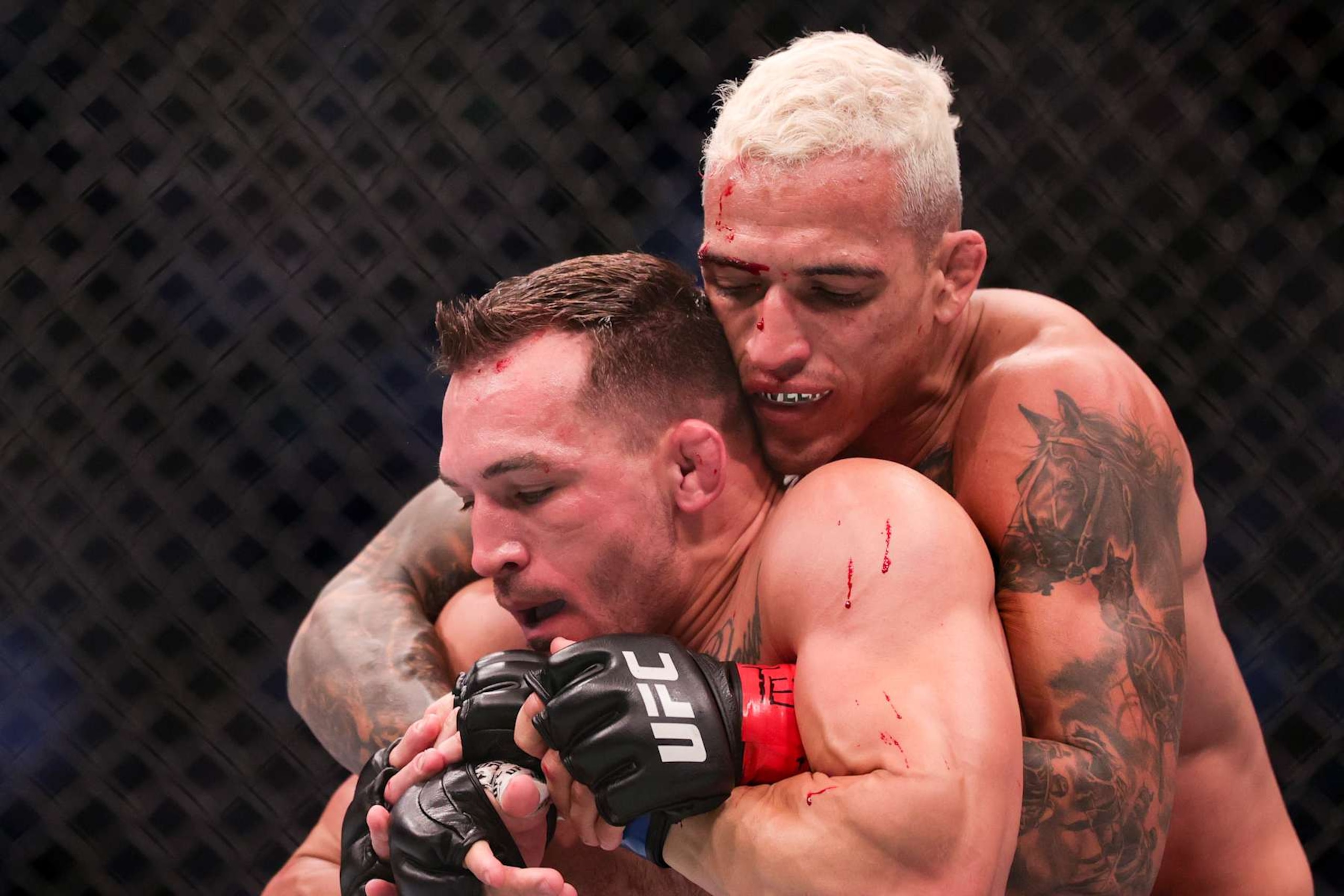 HOUSTON, TEXAS - MAY 15: Charles Oliveira of Brazil and Michael Chandler wrestle during their Championship Lightweight Bout at the UFC 262 event at Toyota Center on May 15, 2021 in Houston, Texas. (Photo by Carmen Mandato/Getty Images)