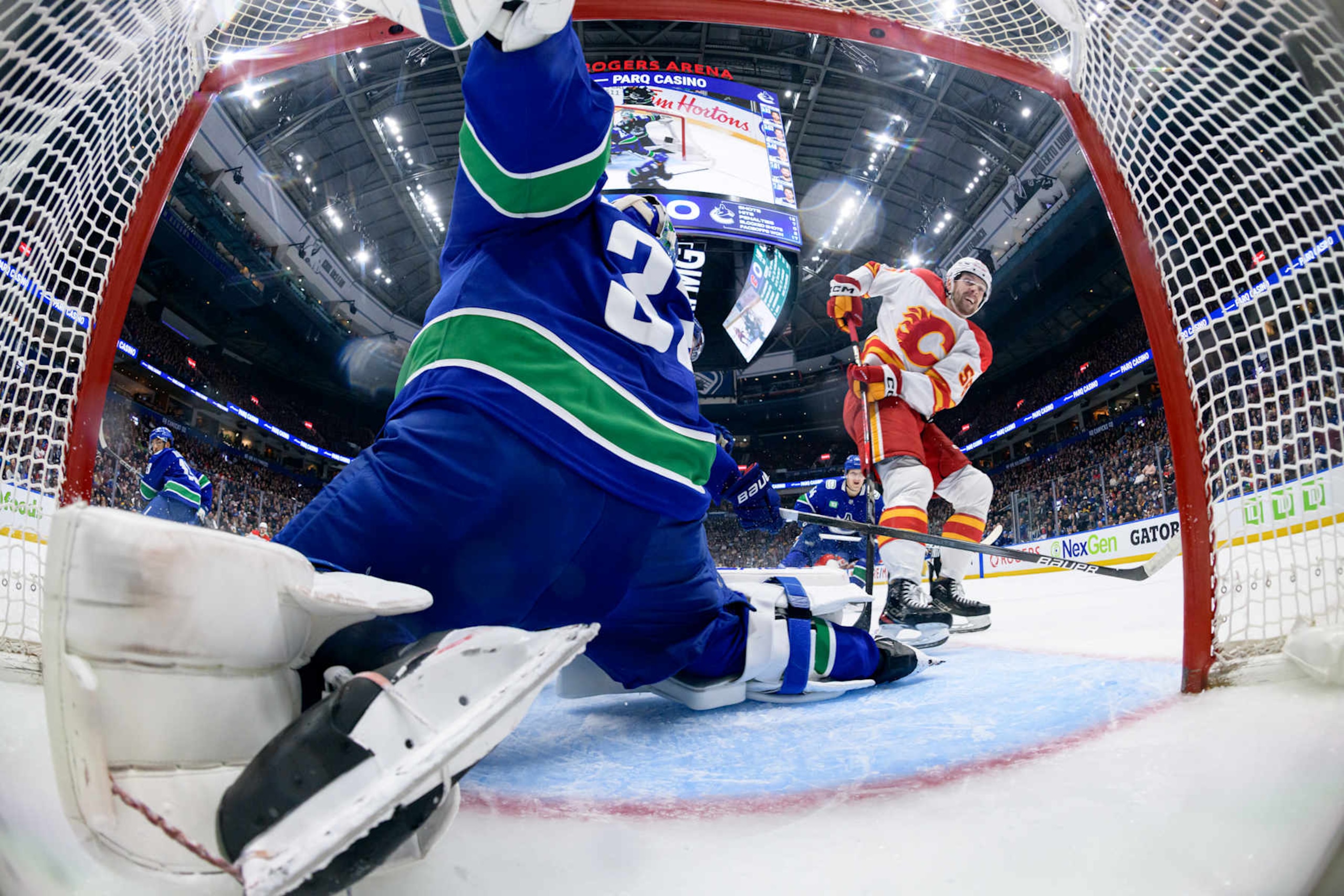 VANCOUVER, CANADA - NOVEMBER 12: Justin Kirkland #58 of the Calgary Flames scores a goal on Kevin Lankinen #32 of the Vancouver Canucks during the second period at Rogers Arena on November 12, 2024 in Vancouver, British Columbia, Canada. (Photo by Derek Cain/Getty Images) VANCOUVER, CANADA - NOVEMBER 12: Justin Kirkland #58 of the Calgary Flames scores a goal on Kevin Lankinen #32 of the Vancouver Canucks during the second period at Rogers Arena on November 12, 2024 in Vancouver, British Columbia, Canada. (Photo by Derek Cain/Getty Images)