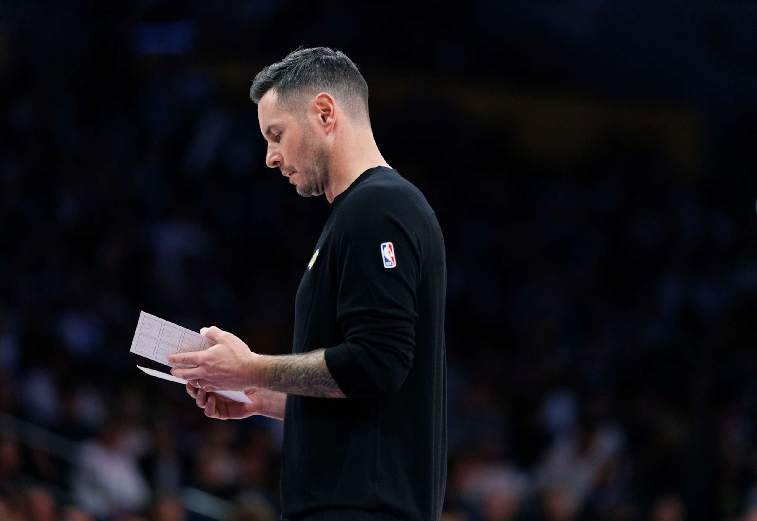 LOS ANGELES, CA - NOVEMBER 10, 2024: Lakers head coach JJ Redick studies his play sheet during a timeout against the Toronto Raptors at Crypto.com Arena on November 10, 2024 in the Los Angeles, California. (Gina Ferazzi / Los Angeles Times via Getty Images)