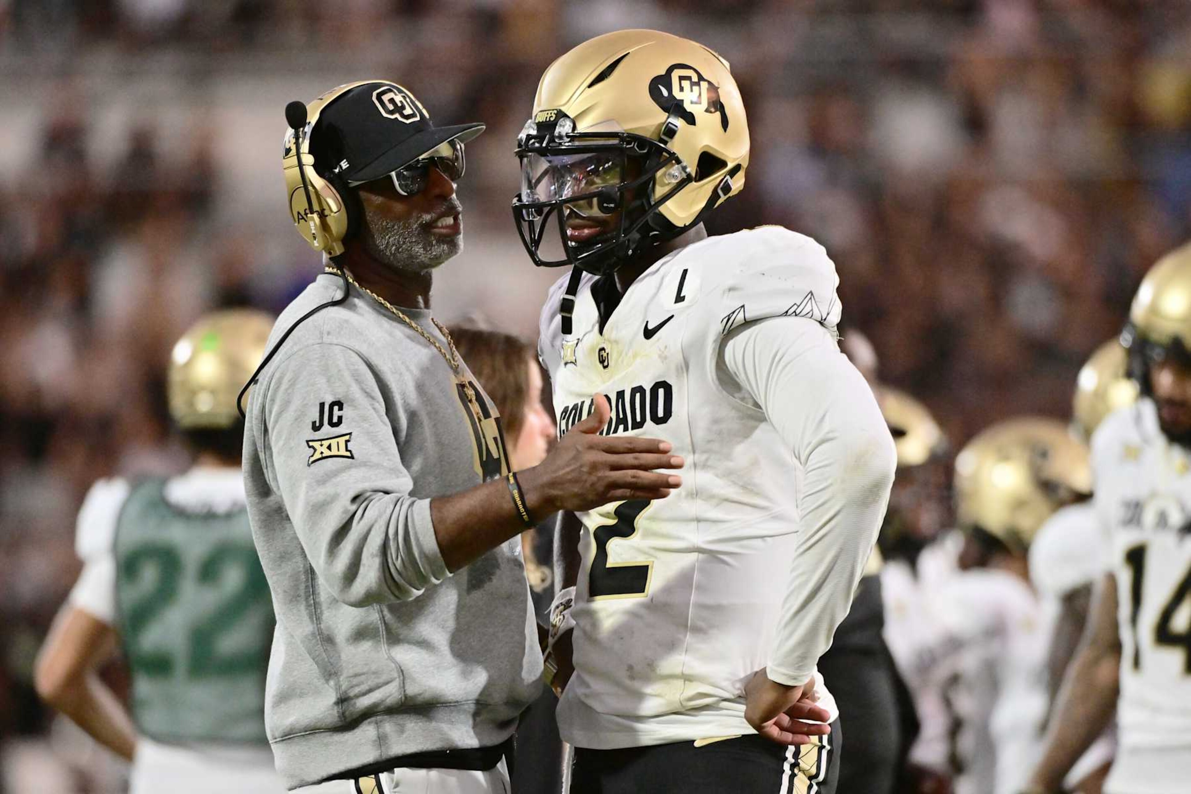 ORLANDO, FLORIDA - SEPTEMBER 28: Head coach Deion Sanders of the Colorado Buffaloes talks with Shedeur Sanders #2 during the second half of a game against the UCF Knights at FBC Mortgage Stadium on September 28, 2024 in Orlando, Florida. (Photo by Julio Aguilar/Getty Images) ORLANDO, FLORIDA - SEPTEMBER 28: Head coach Deion Sanders of the Colorado Buffaloes talks with Shedeur Sanders #2 during the second half of a game against the UCF Knights at FBC Mortgage Stadium on September 28, 2024 in Orlando, Florida. (Photo by Julio Aguilar/Getty Images)