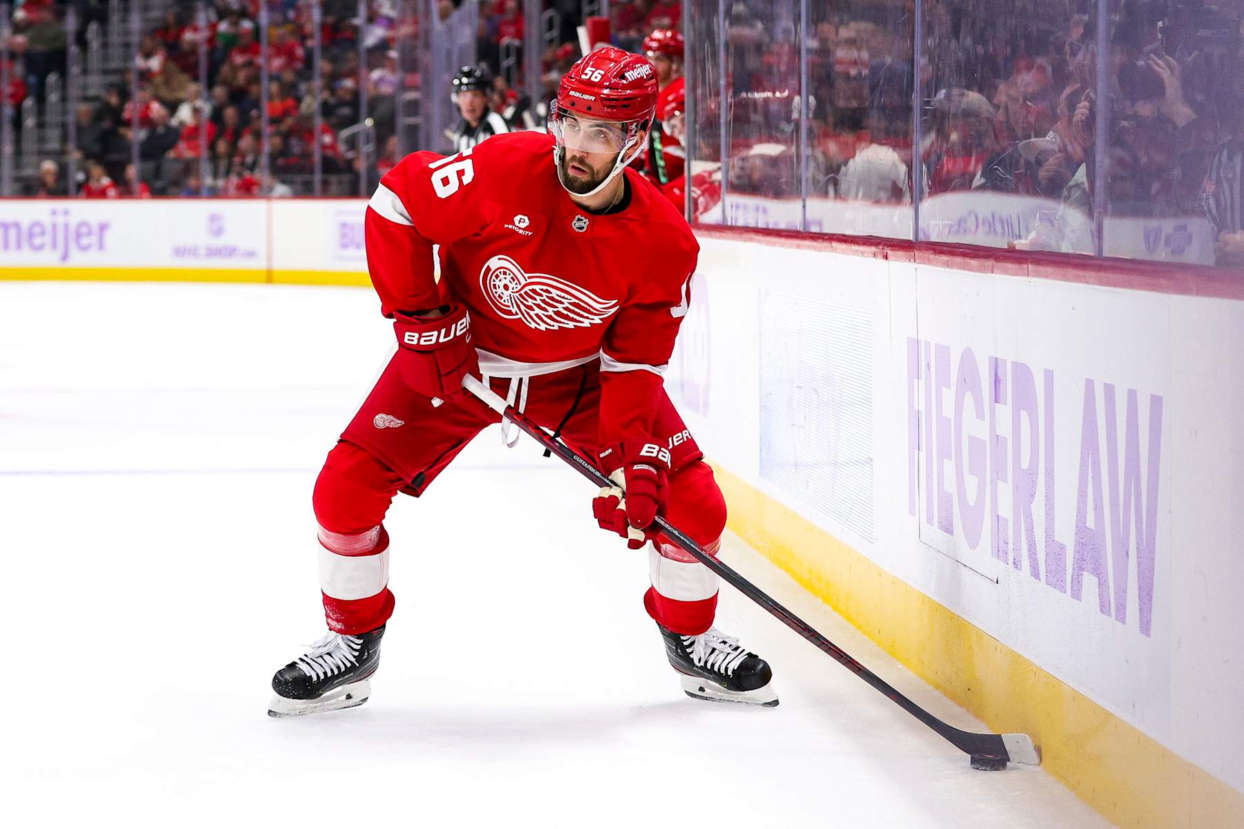DETROIT, MICHIGAN - NOVEMBER 09: Erik Gustafsson #56 of the Detroit Red Wings looks to pass the puck during the second period of a game against the New York Rangers at Little Caesars Arena on November 09, 2024 in Detroit, Michigan. (Photo by Mike Mulholland/Getty Images)
