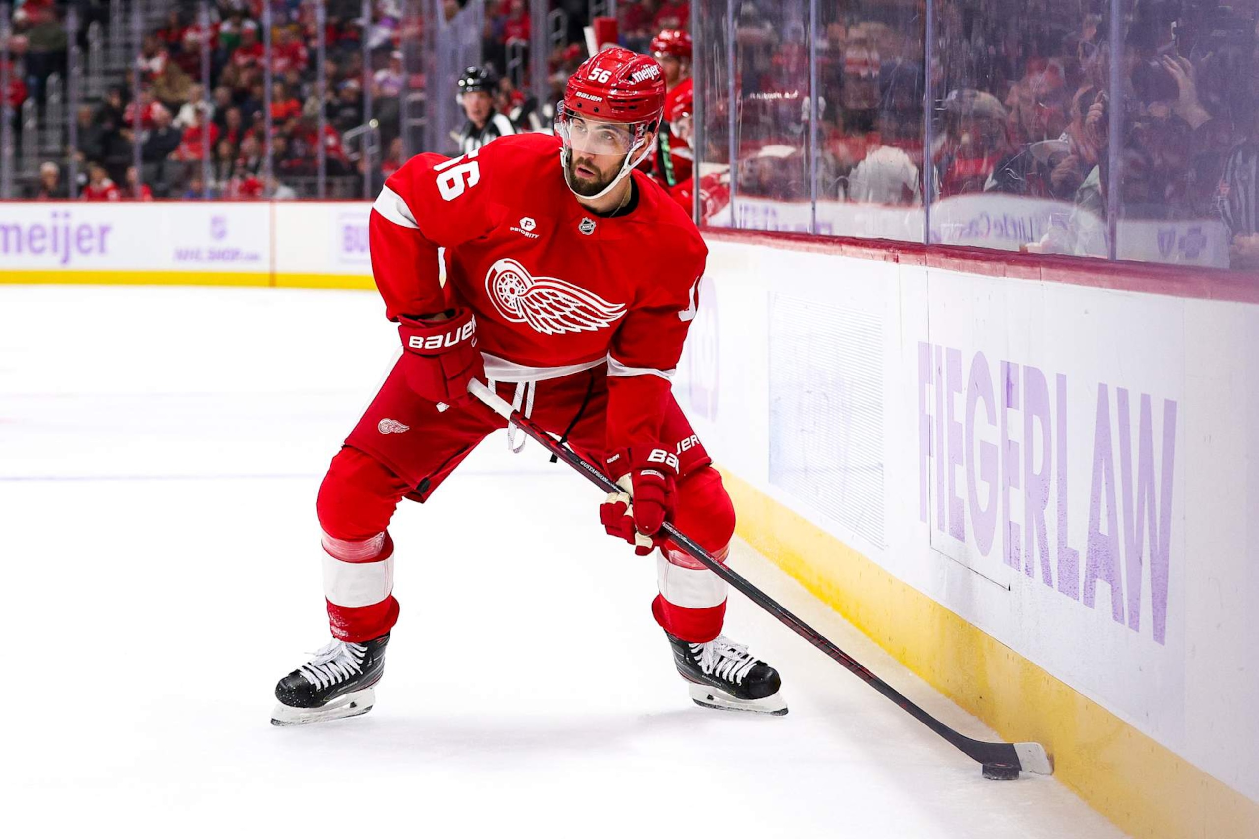 DETROIT, MICHIGAN - NOVEMBER 09: Erik Gustafsson #56 of the Detroit Red Wings looks to pass the puck during the second period of a game against the New York Rangers at Little Caesars Arena on November 09, 2024 in Detroit, Michigan. (Photo by Mike Mulholland/Getty Images)
