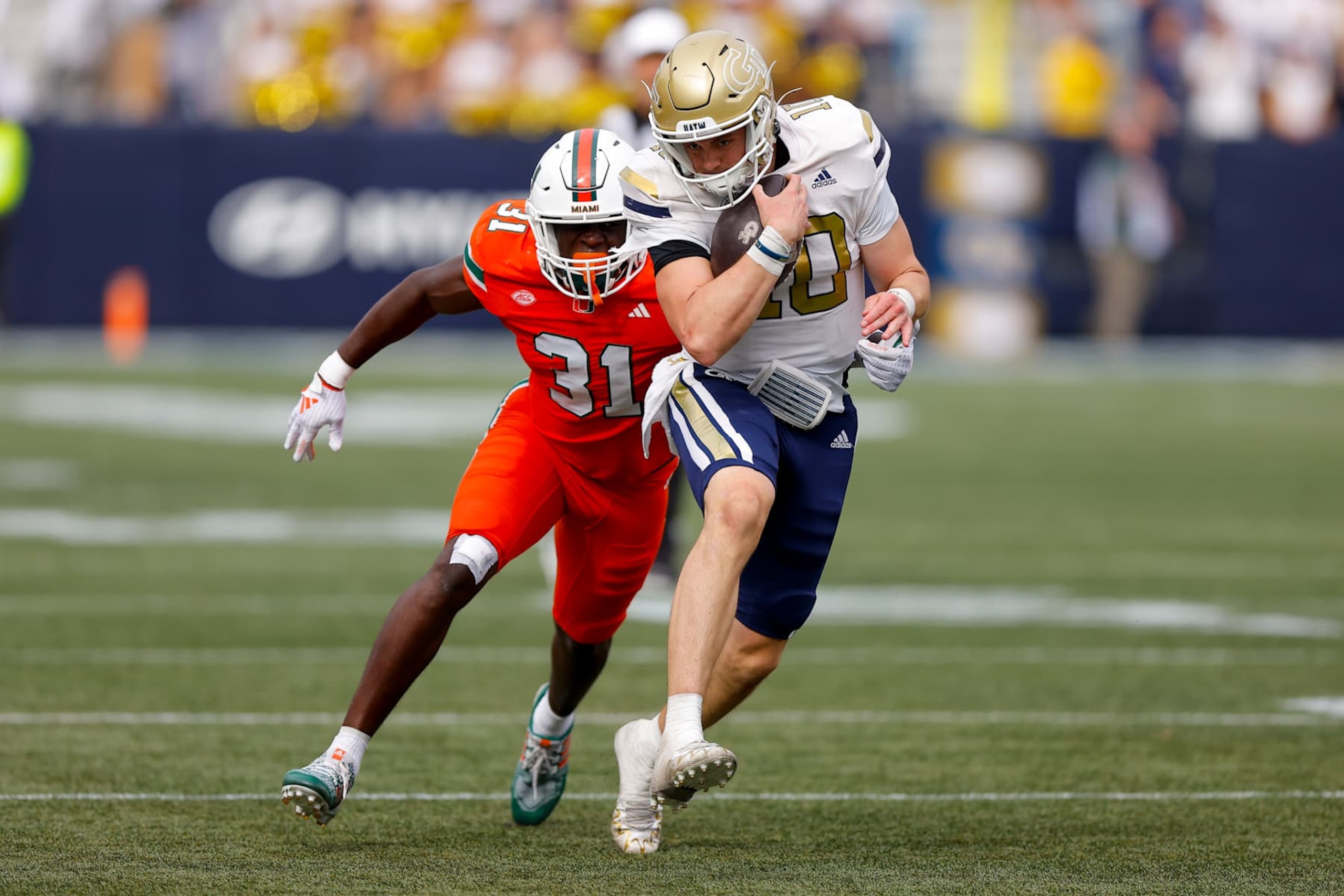 ATLANTA, GEORGIA - NOVEMBER 9: Haynes King #10 of the Georgia Tech Yellow Jackets is pursued by Wesley Bissainthe #31 of the Miami Hurricanes during the third quarter at Bobby Dodd Stadium on November 9, 2024 in Atlanta, Georgia. (Photo by Todd Kirkland/Getty Images)