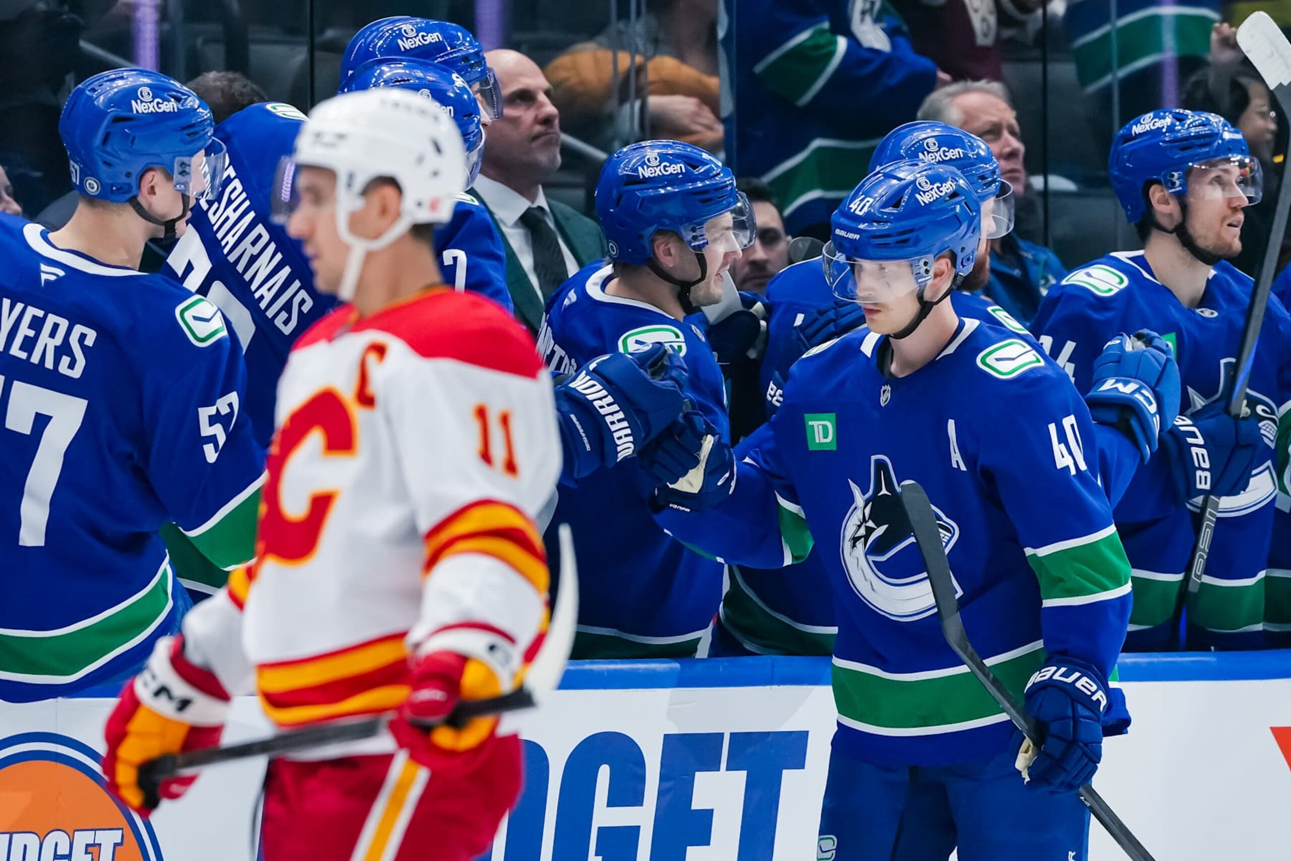 VANCOUVER, CANADA - NOVEMBER 12: Elias Pettersson #40 of the Vancouver Canucks celebrates scoring as Mikael Backlund #11 of the Calgary Flames skates by during the second period at Rogers Arena on November 12, 2024 in Vancouver, British Columbia, Canada. (Photo by Derek Cain/Getty Images) VANCOUVER, CANADA - NOVEMBER 12: Elias Pettersson #40 of the Vancouver Canucks celebrates scoring as Mikael Backlund #11 of the Calgary Flames skates by during the second period at Rogers Arena on November 12, 2024 in Vancouver, British Columbia, Canada. (Photo by Derek Cain/Getty Images)