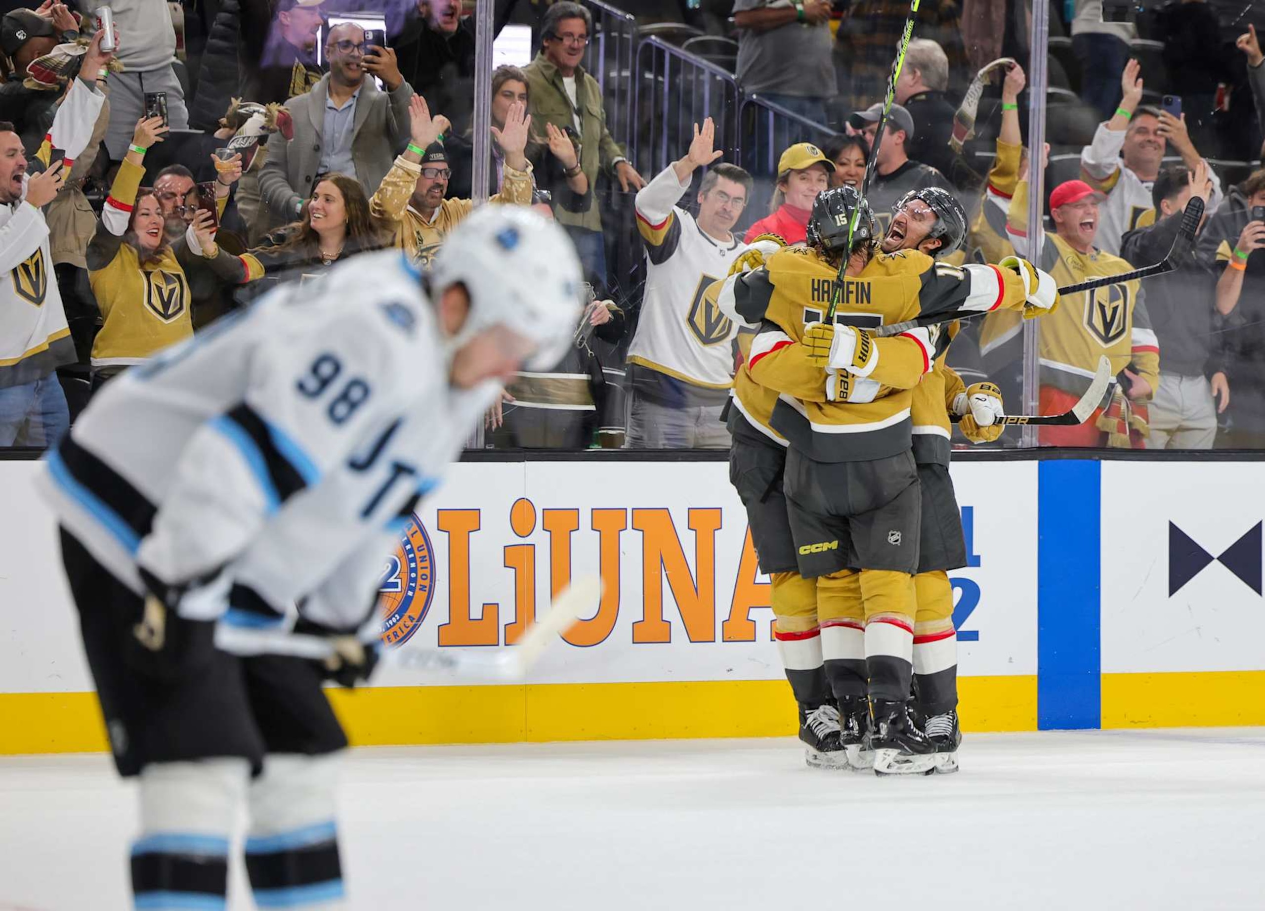 LAS VEGAS, NEVADA - NOVEMBER 02: Mikhail Sergachev #98 of the Utah Hockey Club skates off the ice as Noah Hanifin #15 and Mark Stone (R) #61 of the Vegas Golden Knights celebrate Brett Howden #21 after he scored a goal in overtime against the Hockey Club to win the game 4-3 at T-Mobile Arena on November 02, 2024 in Las Vegas, Nevada. (Photo by Ethan Miller/Getty Images) LAS VEGAS, NEVADA - NOVEMBER 02: Mikhail Sergachev #98 of the Utah Hockey Club skates off the ice as Noah Hanifin #15 and Mark Stone (R) #61 of the Vegas Golden Knights celebrate Brett Howden #21 after he scored a goal in overtime against the Hockey Club to win the game 4-3 at T-Mobile Arena on November 02, 2024 in Las Vegas, Nevada. (Photo by Ethan Miller/Getty Images)
