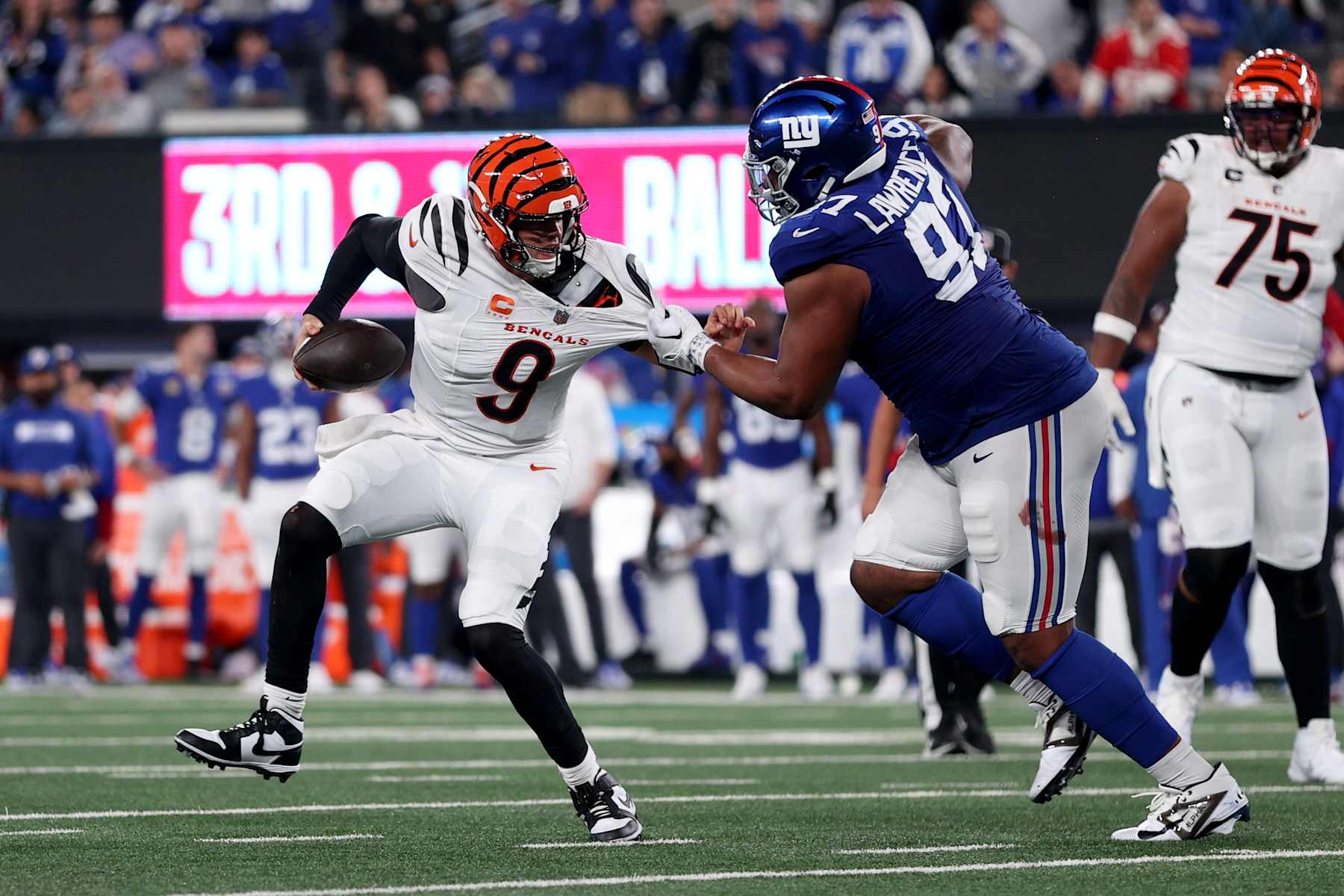 EAST RUTHERFORD, NEW JERSEY - OCTOBER 13: Joe Burrow #9 of the Cincinnati Bengals is sacked by Dexter Lawrence II #97 of the New York Giants during the second half at MetLife Stadium on October 13, 2024 in East Rutherford, New Jersey. (Photo by Sarah Stier/Getty Images)
