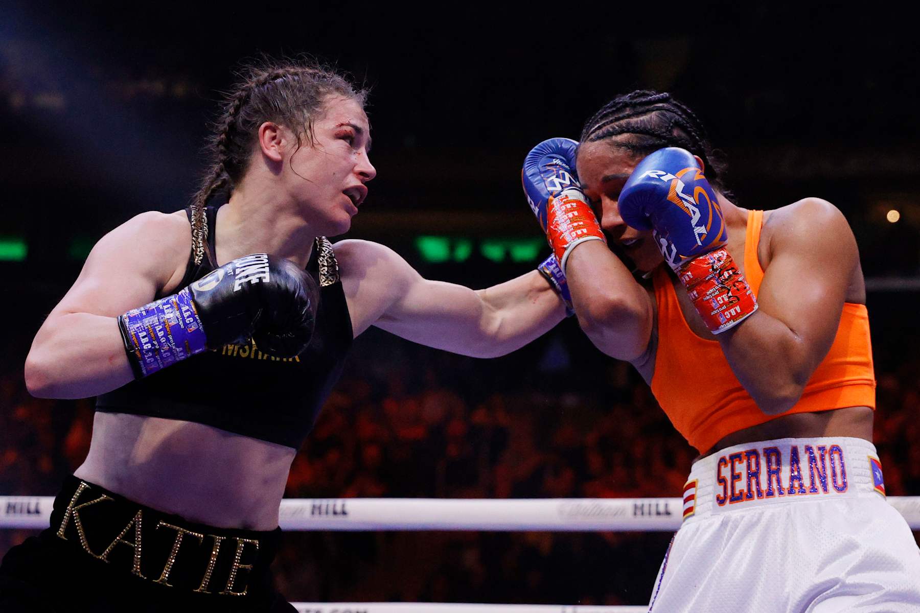 NEW YORK, NEW YORK - APRIL 30: Katie Taylor of Ireland (black trunks) trades punches with Amanda Serrano of Puerto Rico (white trunks) for the World Lightweight Title fight at Madison Square Garden on April 30, 2022 in New York, New York. This bout marks the first women’s boxing fight to headline Madison Square Garden in the venue’s history. Taylor defeated Serrano on a judges decision. (Photo by Sarah Stier/Getty Images)