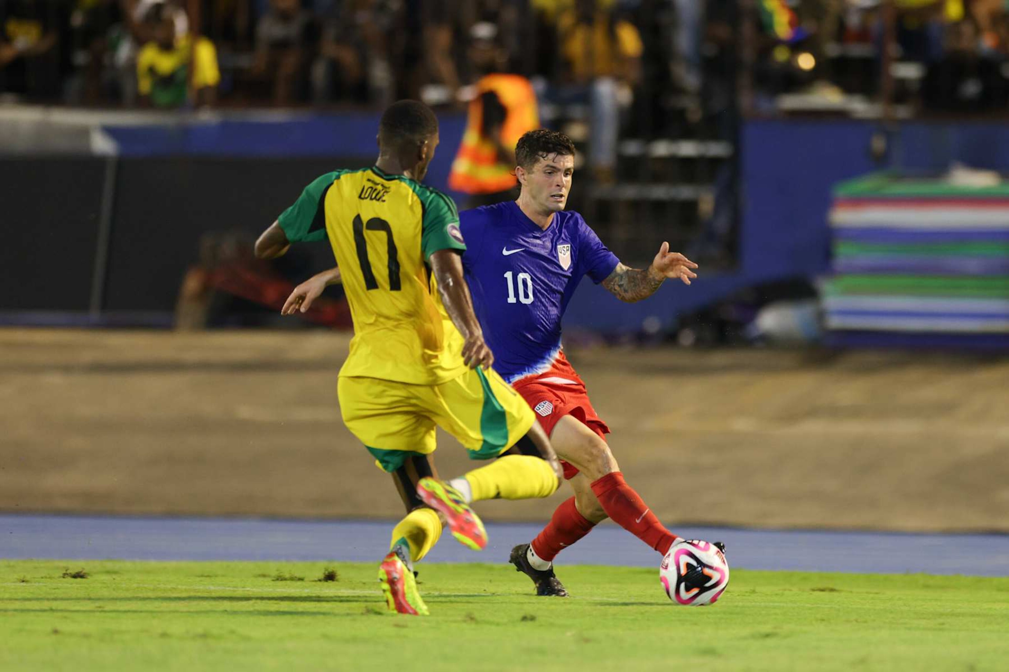 KINGSTON, JAMAICA - NOVEMBER 14: Christian Pulisic #10 of the United States is defended by Damion Lowe #17 of Jamaica during the first half at National Stadium on November 14, 2024 in Kingston, Jamaica. (Photo by John Dorton/ISI Photos/USSF/Getty Images) KINGSTON, JAMAICA - NOVEMBER 14: Christian Pulisic #10 of the United States is defended by Damion Lowe #17 of Jamaica during the first half at National Stadium on November 14, 2024 in Kingston, Jamaica. (Photo by John Dorton/ISI Photos/USSF/Getty Images)