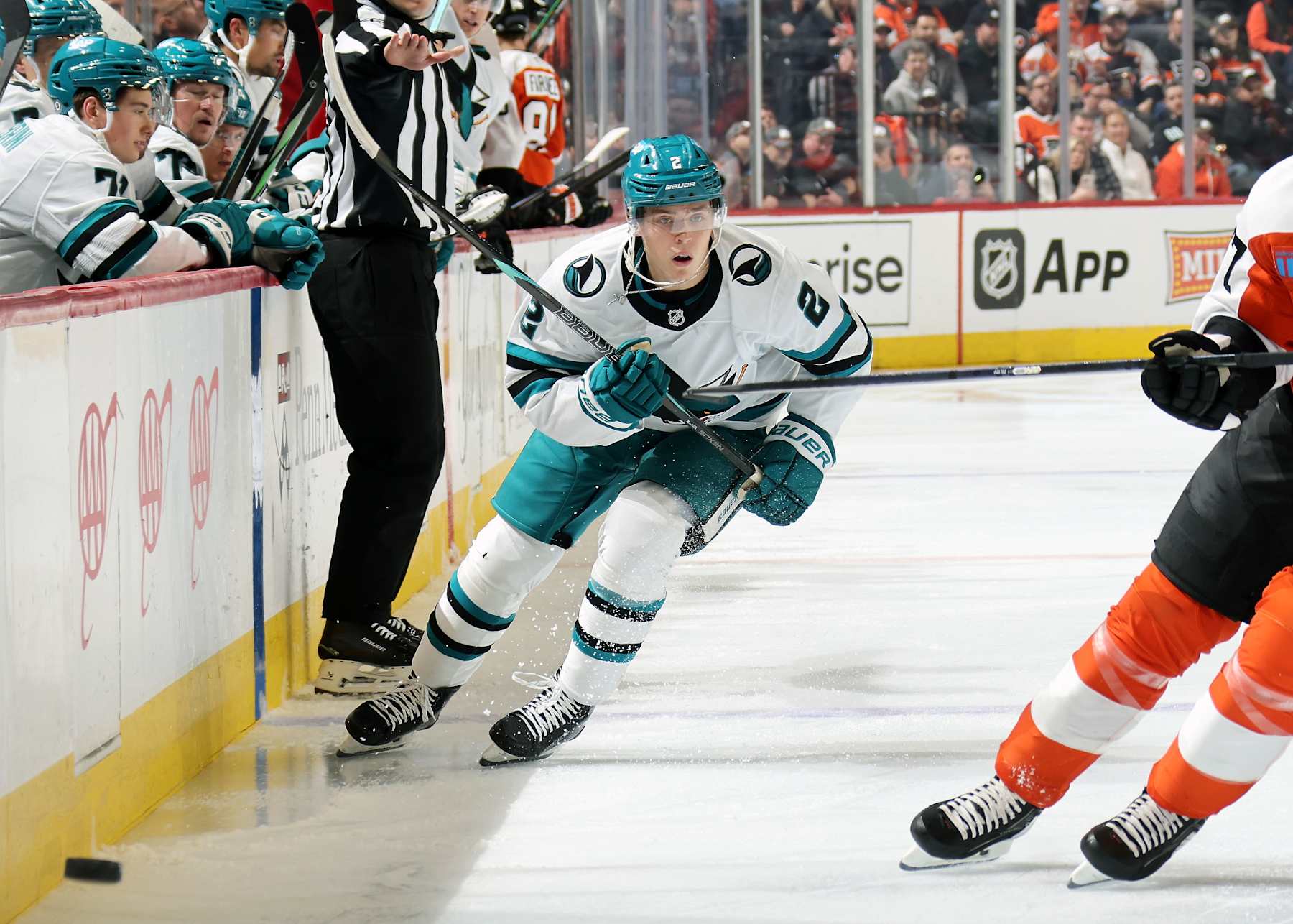 PHILADELPHIA, PENNSYLVANIA - NOVEMBER 11:  Will Smith #2 of the San Jose Sharks dumps the puck along the boards against the Philadelphia Flyers at the Wells Fargo Center on November 11, 2024 in Philadelphia, Pennsylvania.  (Photo by Len Redkoles/NHLI via Getty Images)