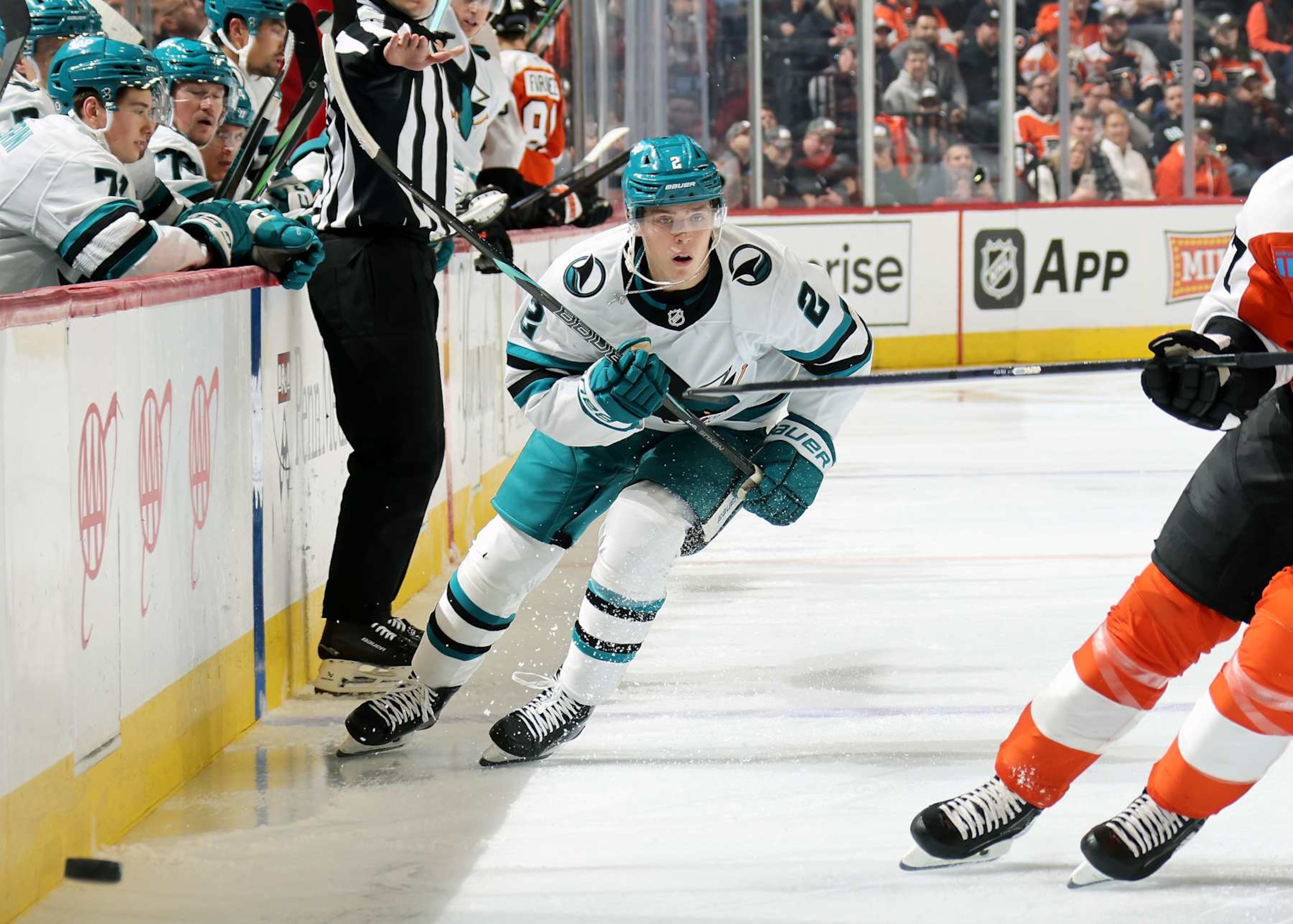 PHILADELPHIA, PENNSYLVANIA - NOVEMBER 11:  Will Smith #2 of the San Jose Sharks dumps the puck along the boards against the Philadelphia Flyers at the Wells Fargo Center on November 11, 2024 in Philadelphia, Pennsylvania.  (Photo by Len Redkoles/NHLI via Getty Images)