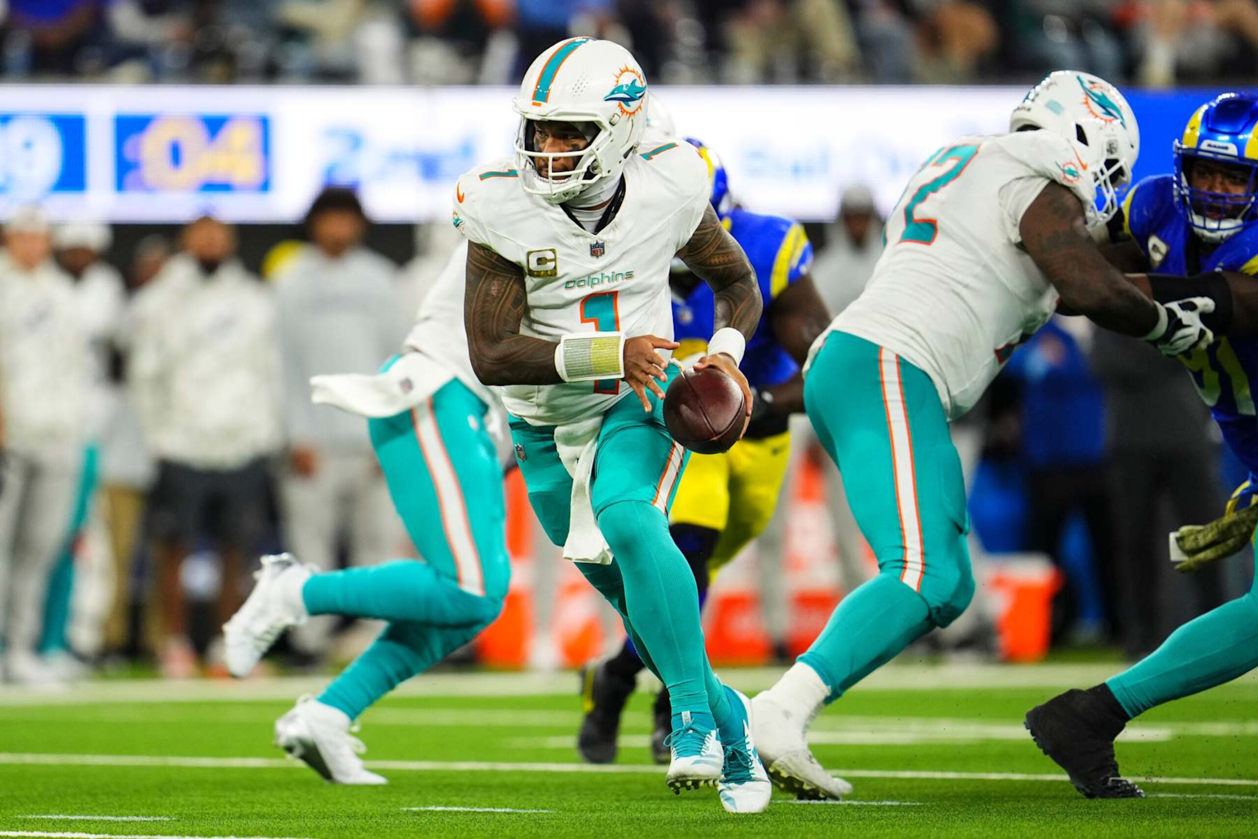 INGLEWOOD, CA - NOVEMBER 11: Tua Tagovailoa #1 of the Miami Dolphins hands the ball off during an NFL football game against the Los Angeles Rams at SoFi Stadium on November 11, 2024 in Inglewood, California. (Photo by Cooper Neill/Getty Images)