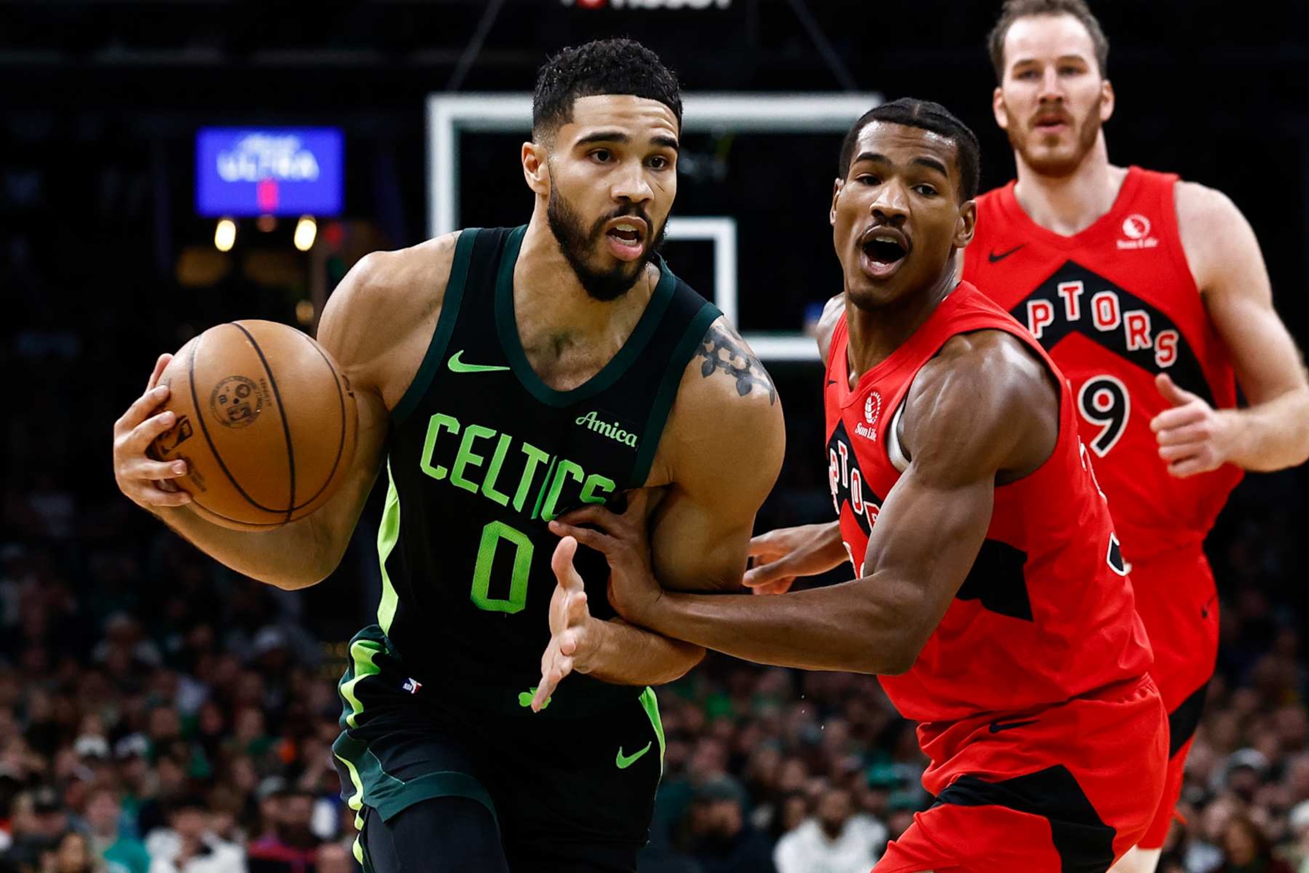 BOSTON, MA - NOVEMBER 16: Jayson Tatum #0 of the Boston Celtics goes past Ochai Agbaji #30 of the Toronto Raptors during the first quarter at TD Garden on November 16, 2024 in Boston, Massachusetts. NOTE TO USER: User expressly acknowledges and agrees that, by downloading and/or using this Photograph, user is consenting to the terms and conditions of the Getty Images License Agreement. (Photo By Winslow Townson/Getty Images)