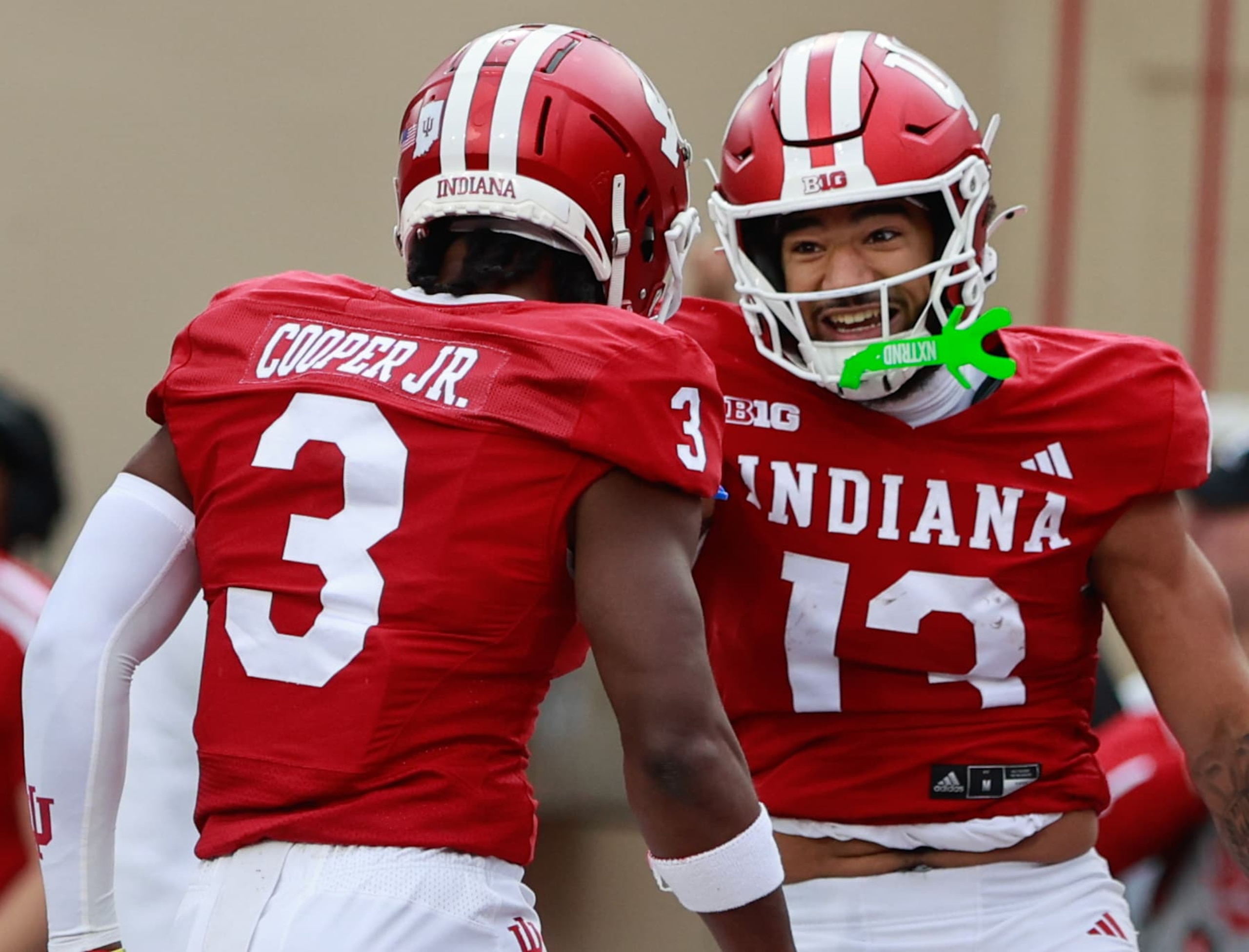 BLOOMINGTON, INDIANA, UNITED STATES - 2024/11/09: Indiana Hoosiers wide receiver Elijah Sarratt (13) celebrates after scoring a touchdown catch during an NCAA football game against Michigan in Bloomington, Ind. Indiana beat Michigan 20-15. (Photo by Jeremy Hogan/SOPA Images/LightRocket via Getty Images) BLOOMINGTON, INDIANA, UNITED STATES - 2024/11/09: Indiana Hoosiers wide receiver Elijah Sarratt (13) celebrates after scoring a touchdown catch during an NCAA football game against Michigan in Bloomington, Ind. Indiana beat Michigan 20-15. (Photo by Jeremy Hogan/SOPA Images/LightRocket via Getty Images)