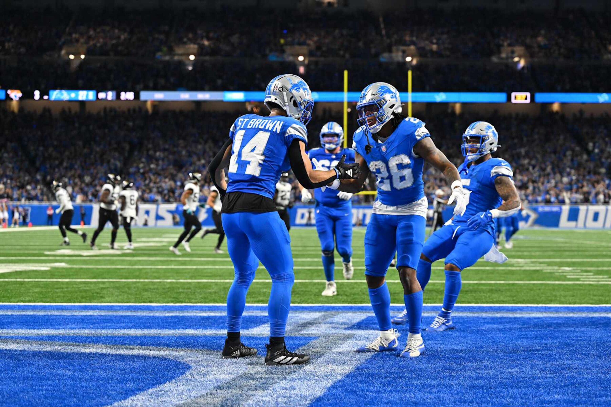 DETROIT, MI - NOVEMBER 17: Detroit Lions wide receiver Amon-Ra St. Brown (14) is congratulated by Detroit Lions running back Jahmyr Gibbs (26) during the Detroit Lions versus the Jacksonville Jaguars game on Sunday November 17, 2024 at Ford Field in Detroit, MI. (Photo by Steven King/Icon Sportswire via Getty Images)