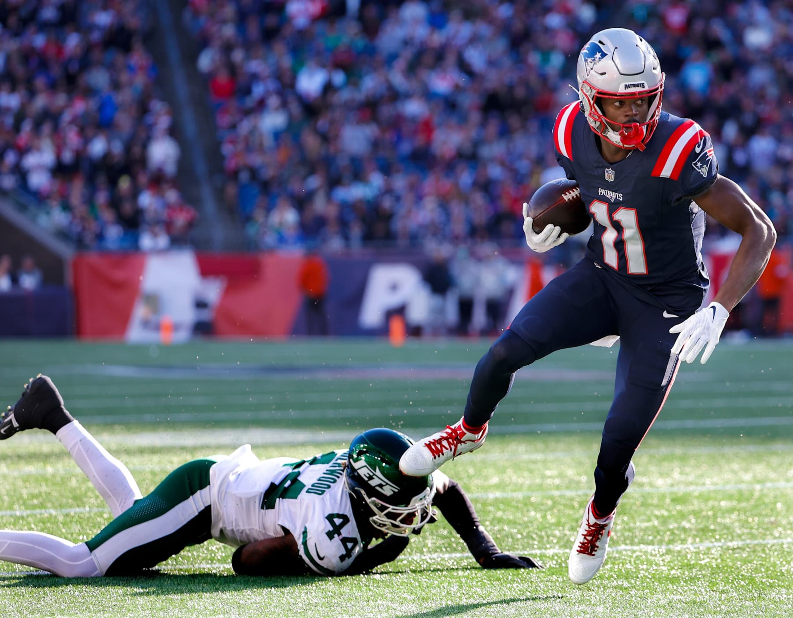 Foxborough, MA - October 27: New England Patriots WR Tyquan Thornton slips a tackle by New York Jets LB Jamien Sherwood in the fourth quarter. (Photo by Matthew J. Lee/The Boston Globe via Getty Images)