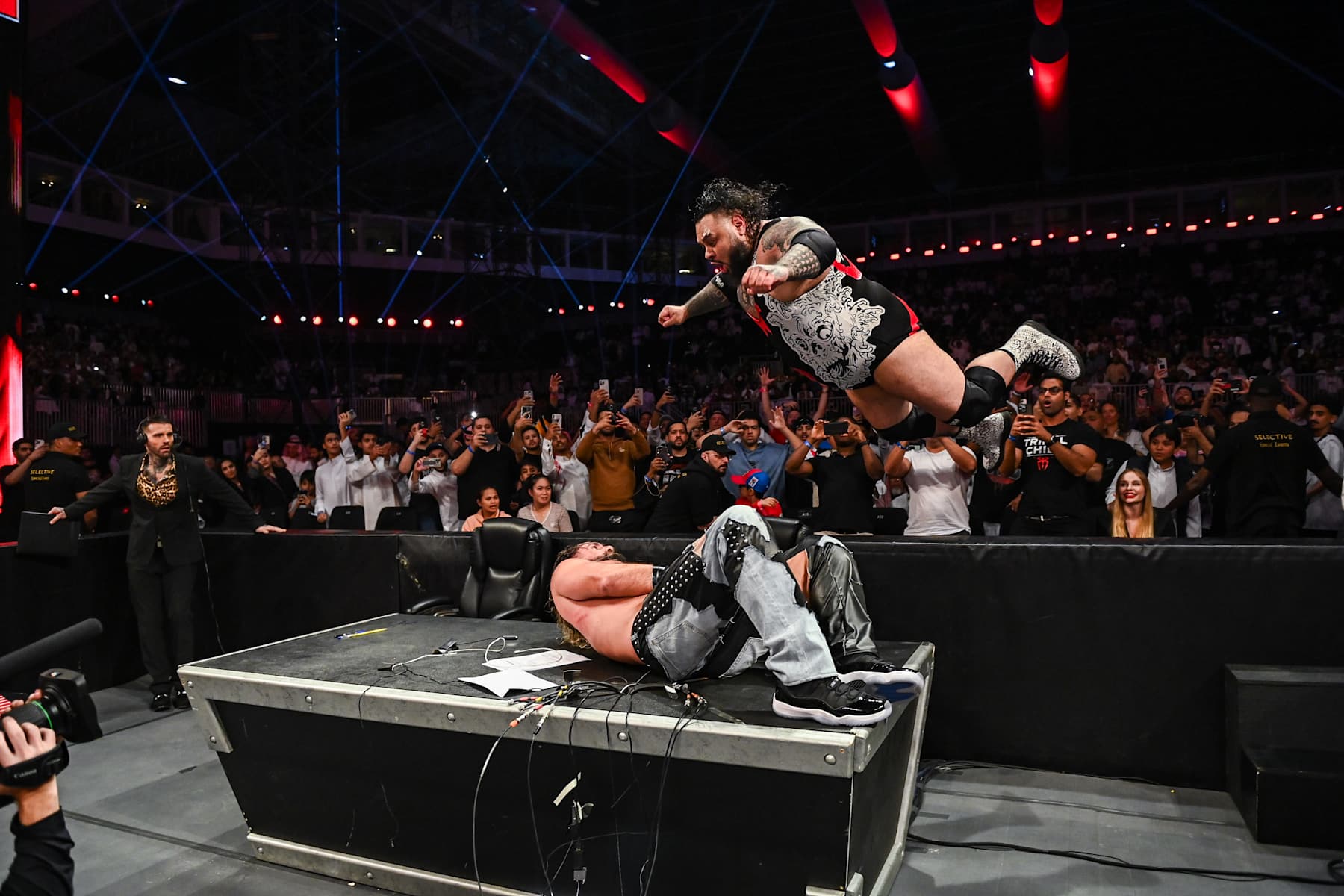 RIYADH, SAUDI ARABIA - NOVEMBER 4: Bronson Reed delivers a Tsunami to Seth Rollins on the Announcer's Desk during Monday Night RAW at Mohammed Abdo Arena on November 4, 2024 in Riyadh, Saudi Arabia.  (Photo by WWE/Getty Images)