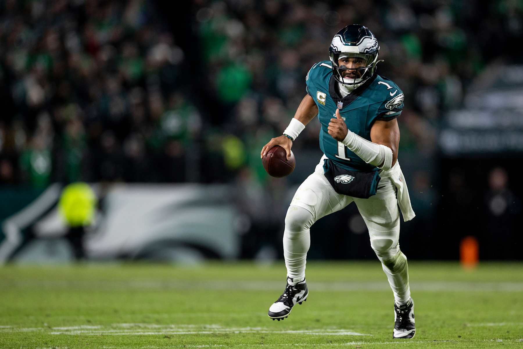 PHILADELPHIA, PENNSYLVANIA - NOVEMBER 14: Jalen Hurts #1 of the Philadelphia Eagles scrambles and runs with the ball during an NFL Football game against the Washington Commanders at Lincoln Financial Field on November 14, 2024 in Philadelphia, Pennsylvania. (Photo by Michael Owens/Getty Images)