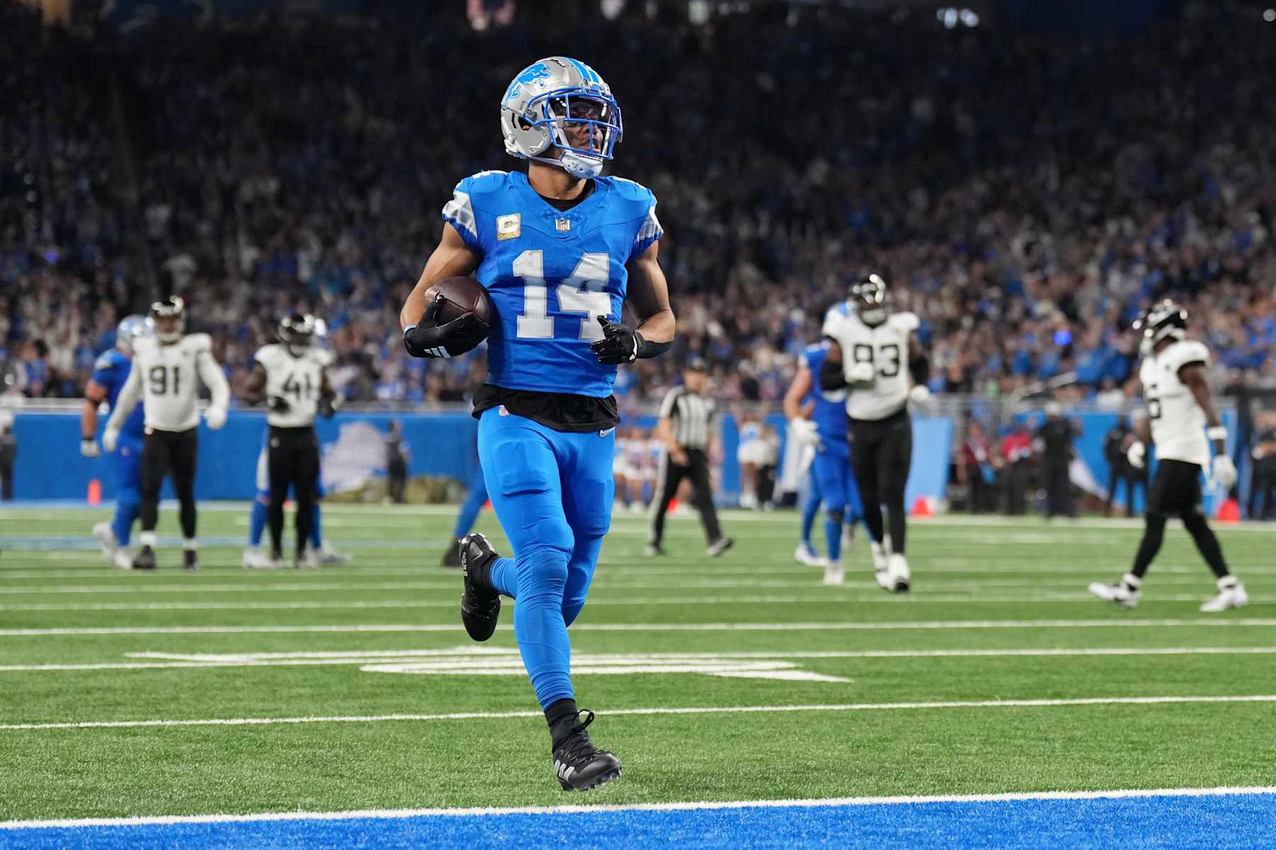 DETROIT, MICHIGAN - NOVEMBER 17: Amon-Ra St. Brown #14 of the Detroit Lions runs the ball for a touchdown in the second quarter of a game against the Jacksonville Jaguars at Ford Field on November 17, 2024 in Detroit, Michigan. (Photo by Nic Antaya/Getty Images)