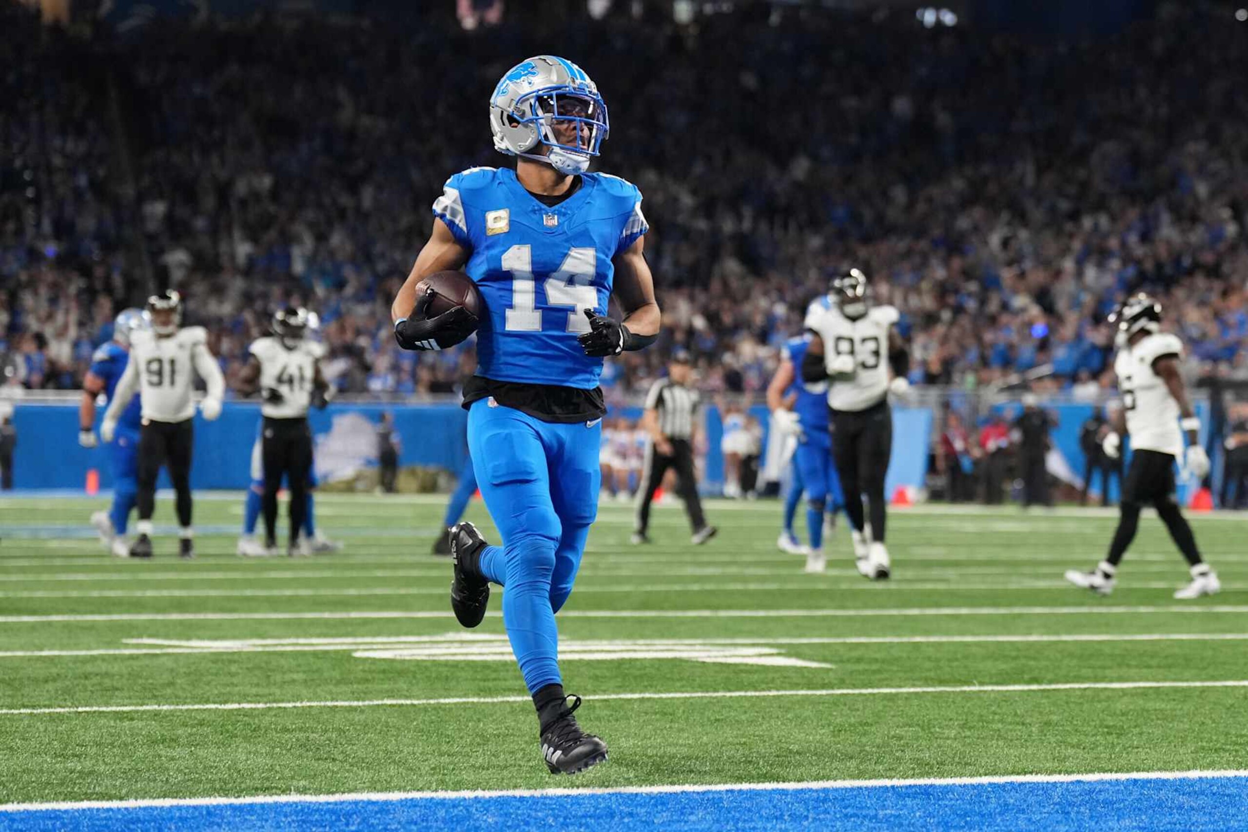 DETROIT, MICHIGAN - NOVEMBER 17: Amon-Ra St. Brown #14 of the Detroit Lions runs the ball for a touchdown in the second quarter of a game against the Jacksonville Jaguars at Ford Field on November 17, 2024 in Detroit, Michigan. (Photo by Nic Antaya/Getty Images) DETROIT, MICHIGAN - NOVEMBER 17: Amon-Ra St. Brown #14 of the Detroit Lions runs the ball for a touchdown in the second quarter of a game against the Jacksonville Jaguars at Ford Field on November 17, 2024 in Detroit, Michigan. (Photo by Nic Antaya/Getty Images)