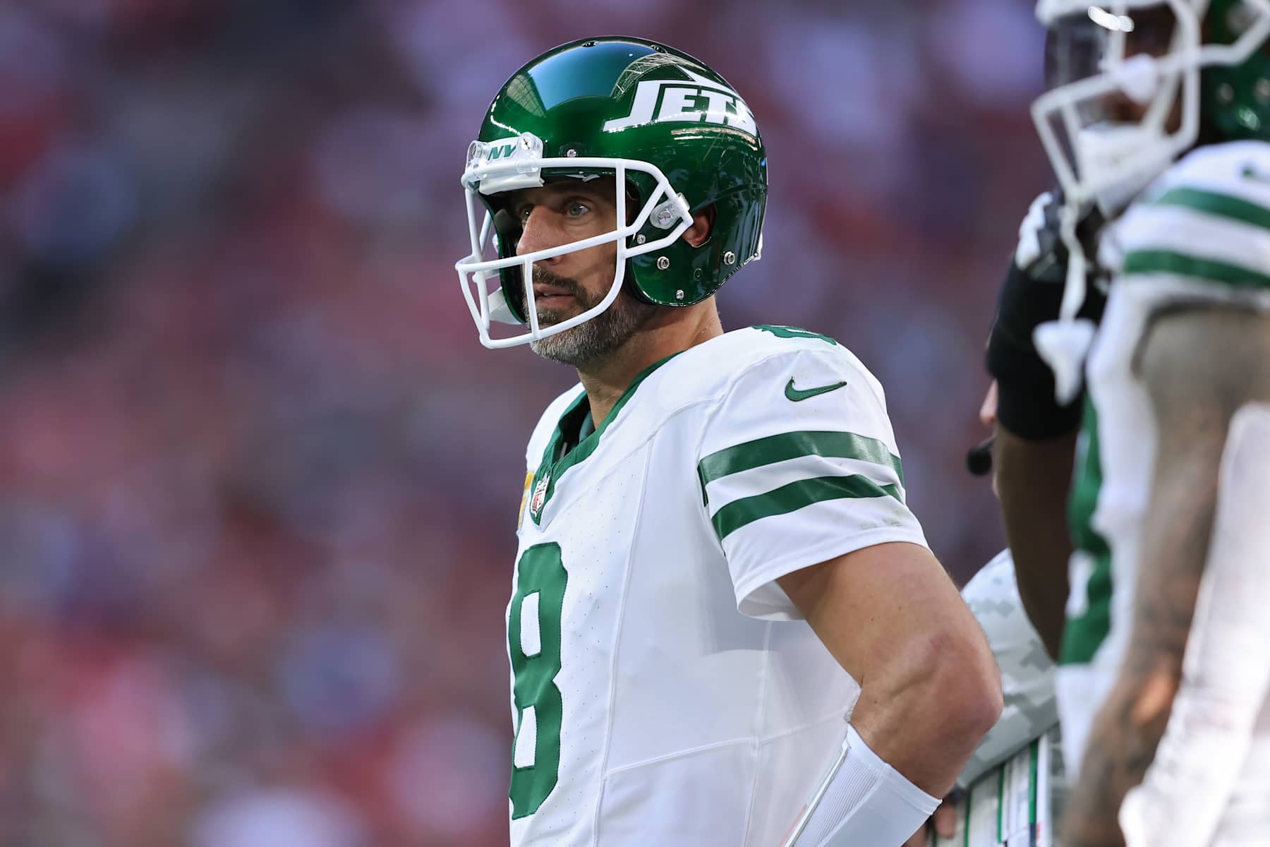 GLENDALE, ARIZONA - NOVEMBER 10: Aaron Rodgers #8 of the New York Jets looks on from the sideline in the second quarter against the Arizona Cardinals at State Farm Stadium on November 10, 2024 in Glendale, Arizona. (Photo by Chris Coduto/Getty Images)