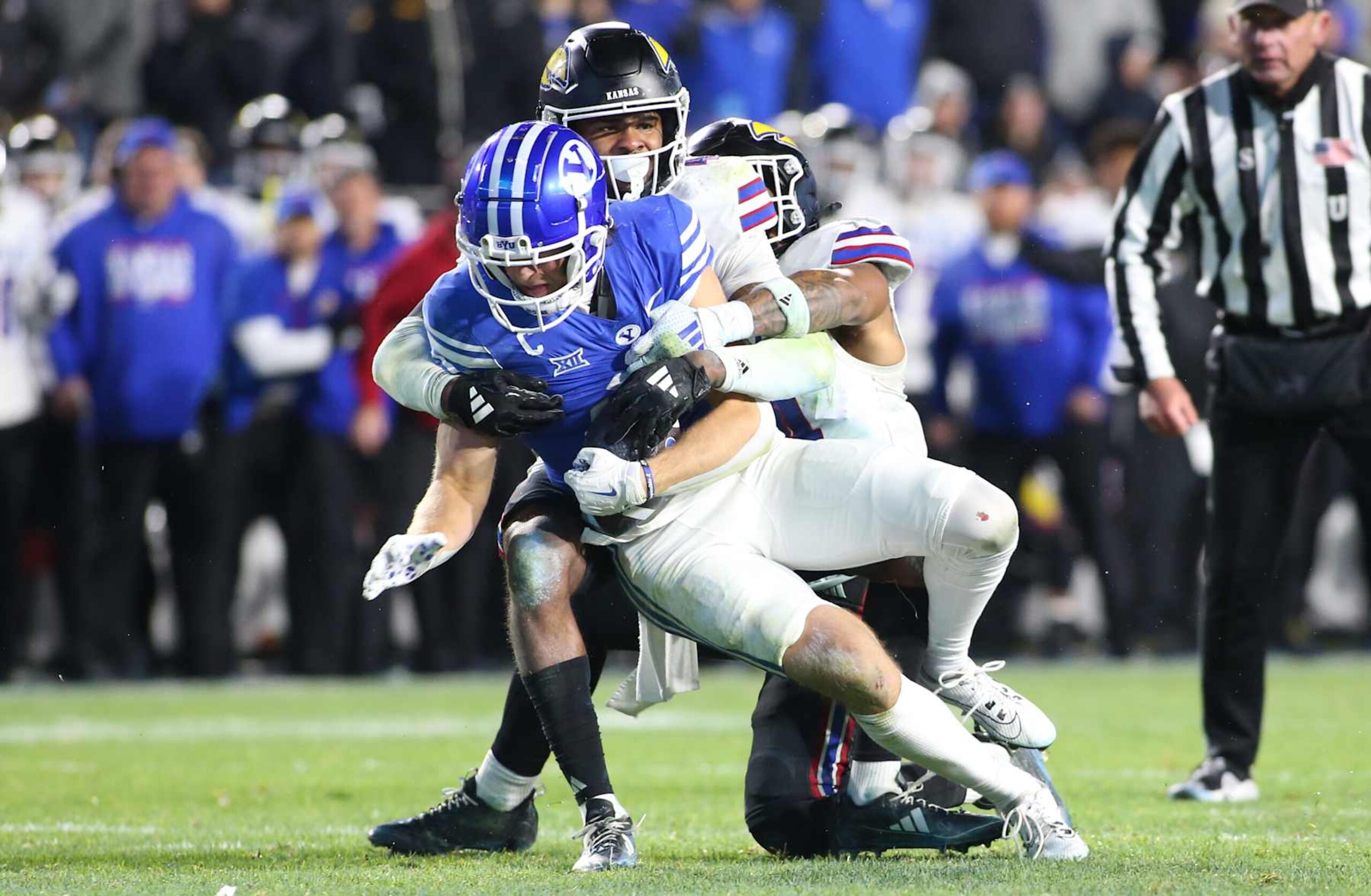 PROVO, UT - NOVEMBER 16: Marvin Grant #4 of the Kansas Jayhawks tackles Chase Roberts #2 of the Brigham Young Cougars short of the first down marker during the final minute of second half of their game at LaVell Edwards Stadium on November 16, 2024 in Provo, Utah.(Photo by Chris Gardner/Getty Images) PROVO, UT - NOVEMBER 16: Marvin Grant #4 of the Kansas Jayhawks tackles Chase Roberts #2 of the Brigham Young Cougars short of the first down marker during the final minute of second half of their game at LaVell Edwards Stadium on November 16, 2024 in Provo, Utah.(Photo by Chris Gardner/Getty Images)