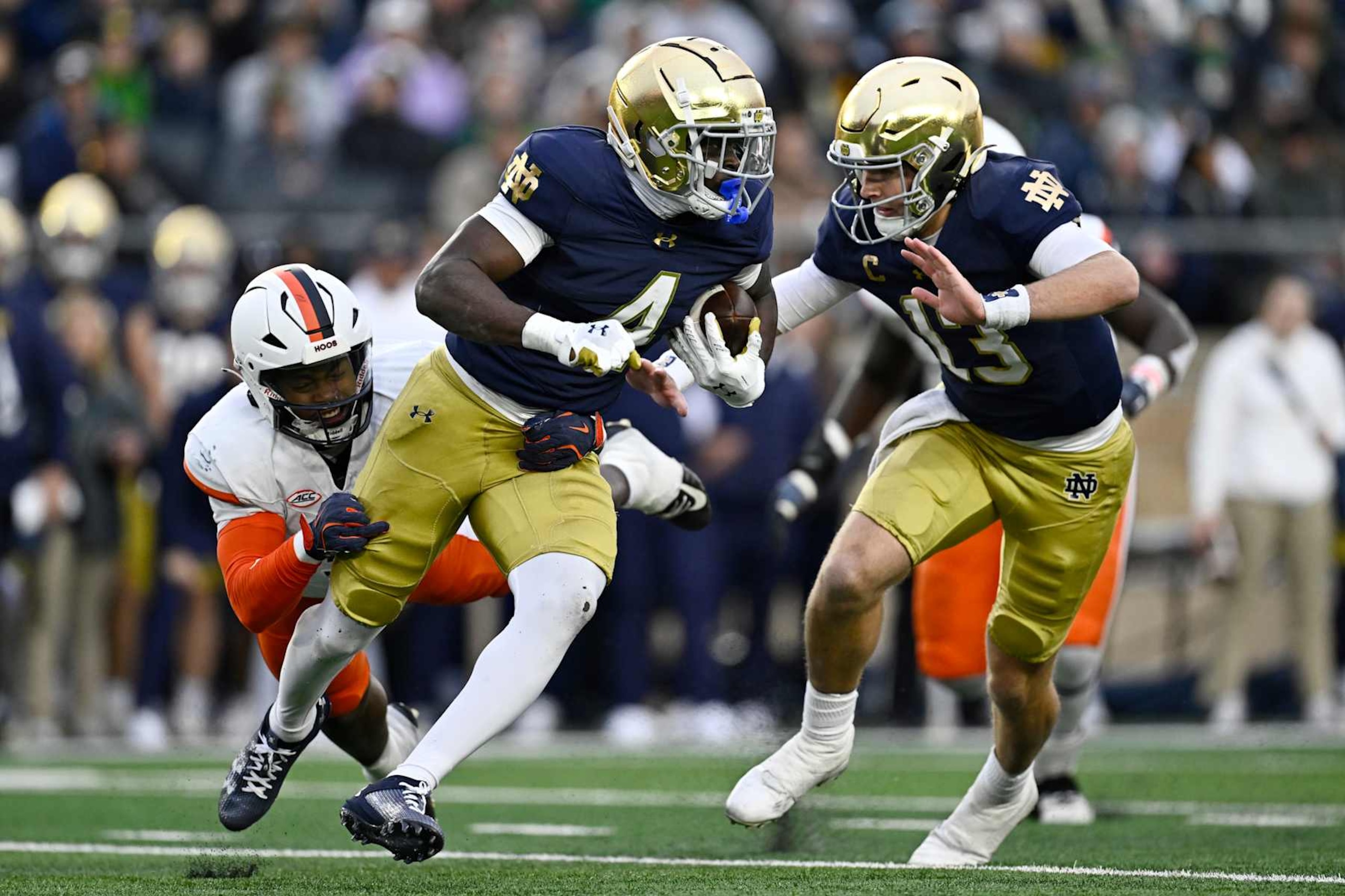 SOUTH BEND, INDIANA - NOVEMBER 16: Jeremiyah Love #4 of the Notre Dame Fighting Irish rushes for a first down in the first half against the Virginia Cavaliers at Notre Dame Stadium on November 16, 2024 in South Bend, Indiana. (Photo by Quinn Harris/Getty Images) SOUTH BEND, INDIANA - NOVEMBER 16: Jeremiyah Love #4 of the Notre Dame Fighting Irish rushes for a first down in the first half against the Virginia Cavaliers at Notre Dame Stadium on November 16, 2024 in South Bend, Indiana. (Photo by Quinn Harris/Getty Images)