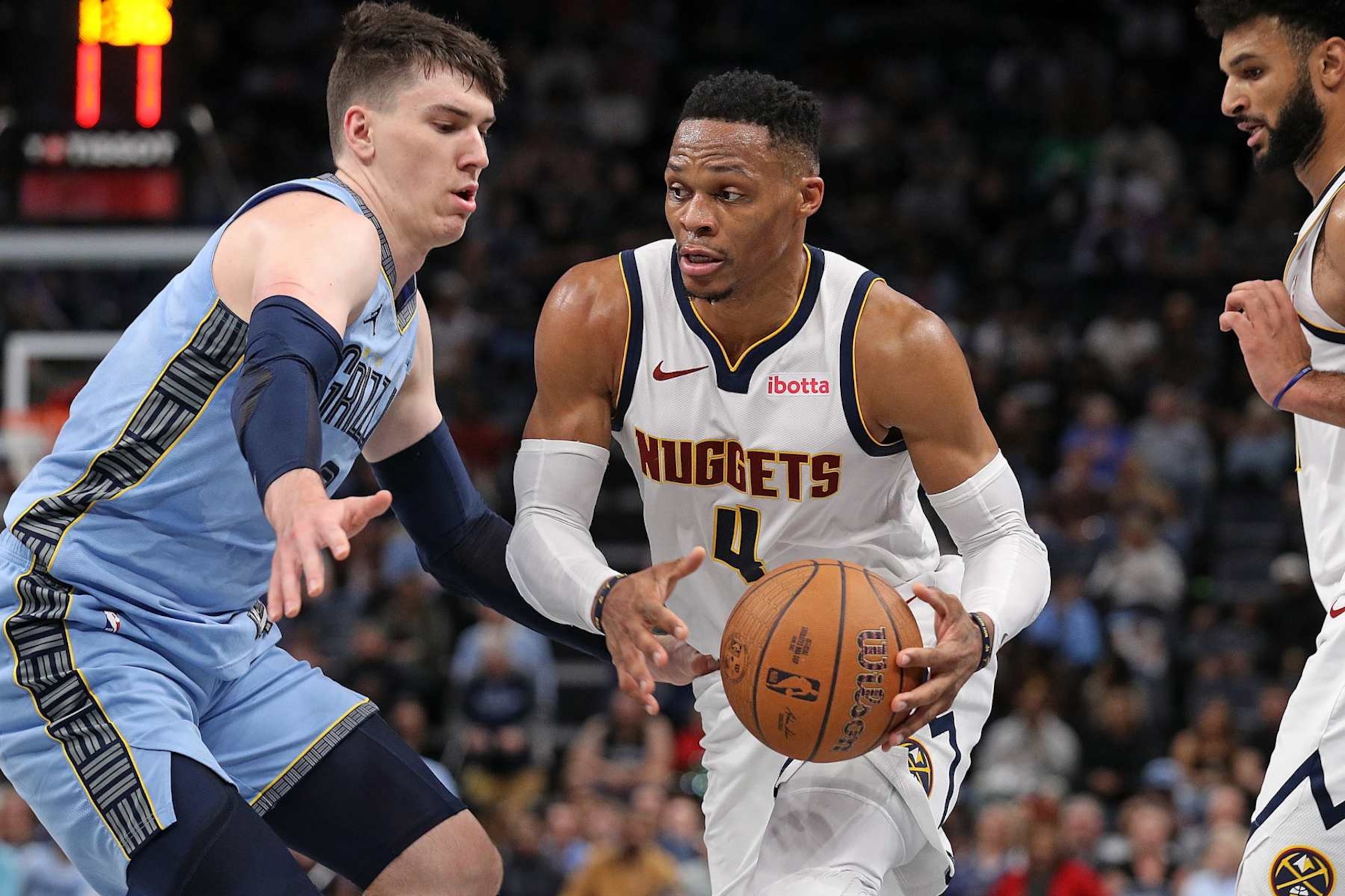 MEMPHIS, TENNESSEE - NOVEMBER 19: Russell Westbrook #4 of the Denver Nuggets handles the ball against Jake LaRavia #3 of the Memphis Grizzlies during the first half of the Emirates NBA Cup at FedExForum on November 19, 2024 in Memphis, Tennessee. NOTE TO USER: User expressly acknowledges and agrees that, by downloading and or using this photograph, User is consenting to the terms and conditions of the Getty Images License Agreement. (Photo by Justin Ford/Getty Images)