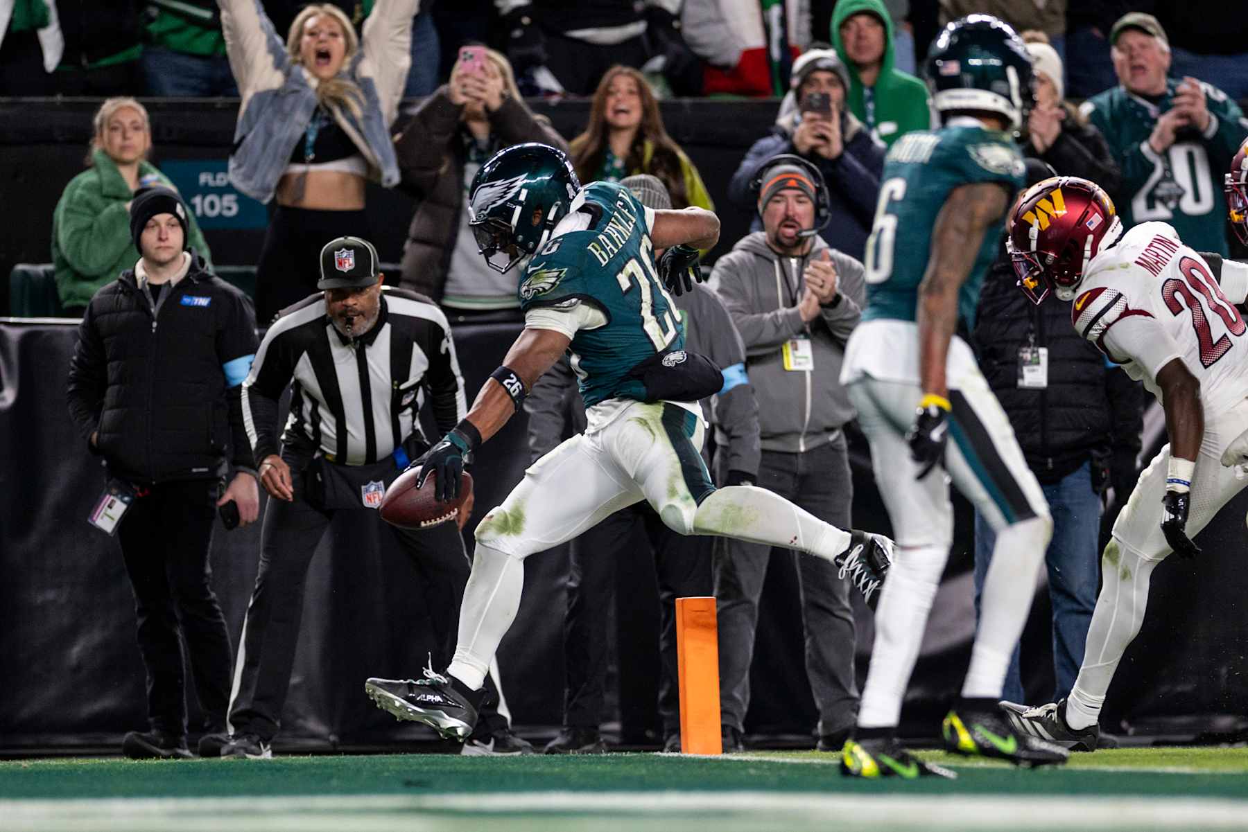 PHILADELPHIA, PENNSYLVANIA - NOVEMBER 14: Saquon Barkley #26 of the Philadelphia Eagles runs with the ball and scores a touchdown during an NFL Football game against the Washington Commanders at Lincoln Financial Field on November 14, 2024 in Philadelphia, Pennsylvania. (Photo by Michael Owens/Getty Images)