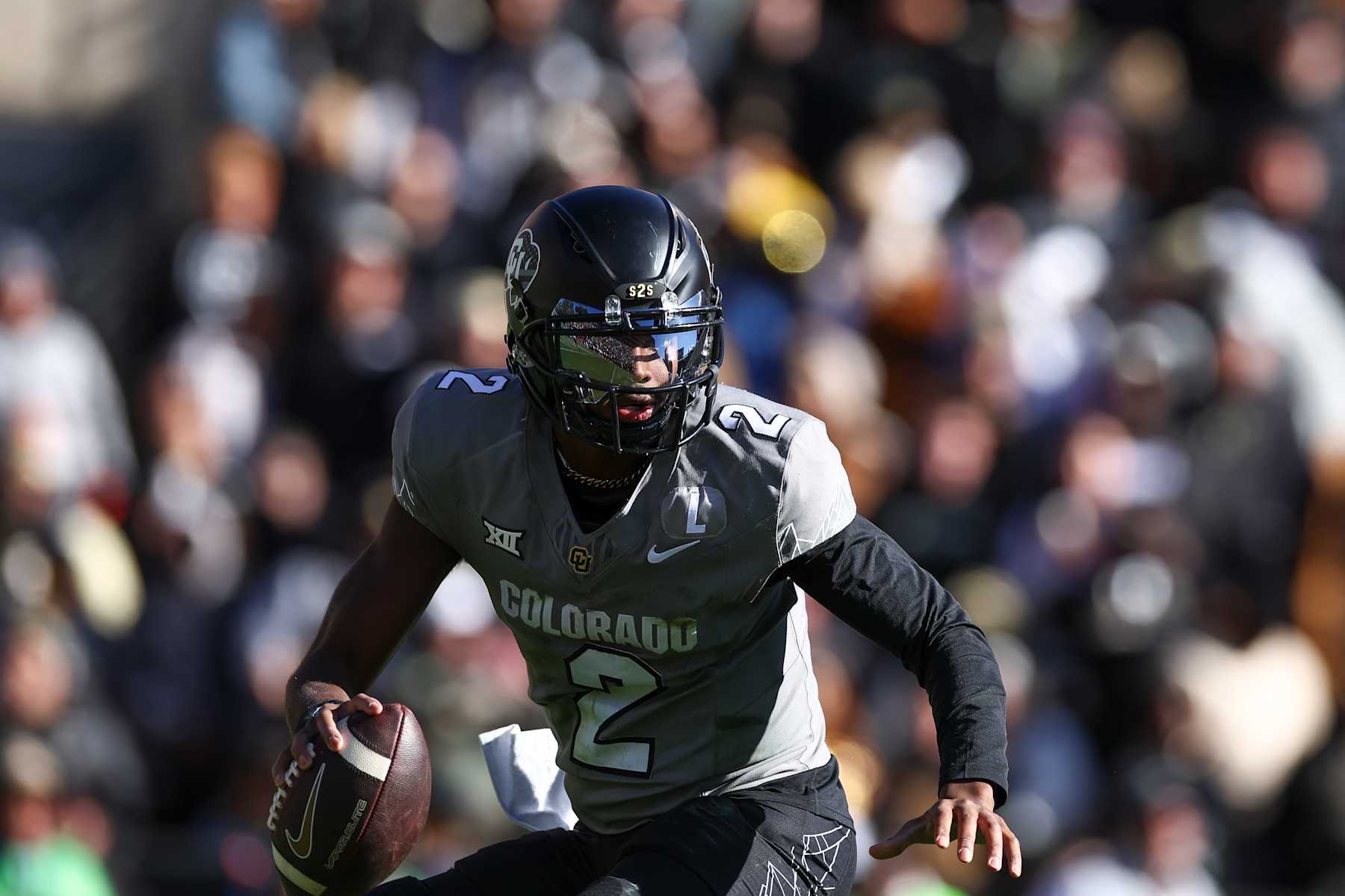 BOULDER, COLORADO - NOVEMBER 16: Travis Hunter #12 of the Colorado Buffaloes scrambles during the first half against the Utah Utes at Folsom Field on November 16, 2024 in Boulder, Colorado. (Photo by Aaron M. Sprecher/Getty Images)