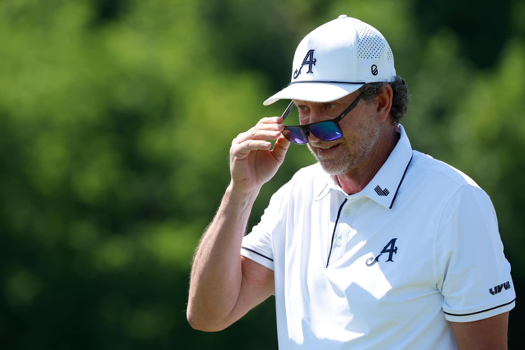 COLLEGE GROVE, TN - JUNE 20: Hockey Hall of Fame member Wayne Gretzky looks over his sunglasses to watch his tee shot during a pro-am practice round during LIV Golf Nashville, June 20, 2024, at The Grove in College Grove, Tennessee.  (Photo by Matthew Maxey/Icon Sportswire via Getty Images)