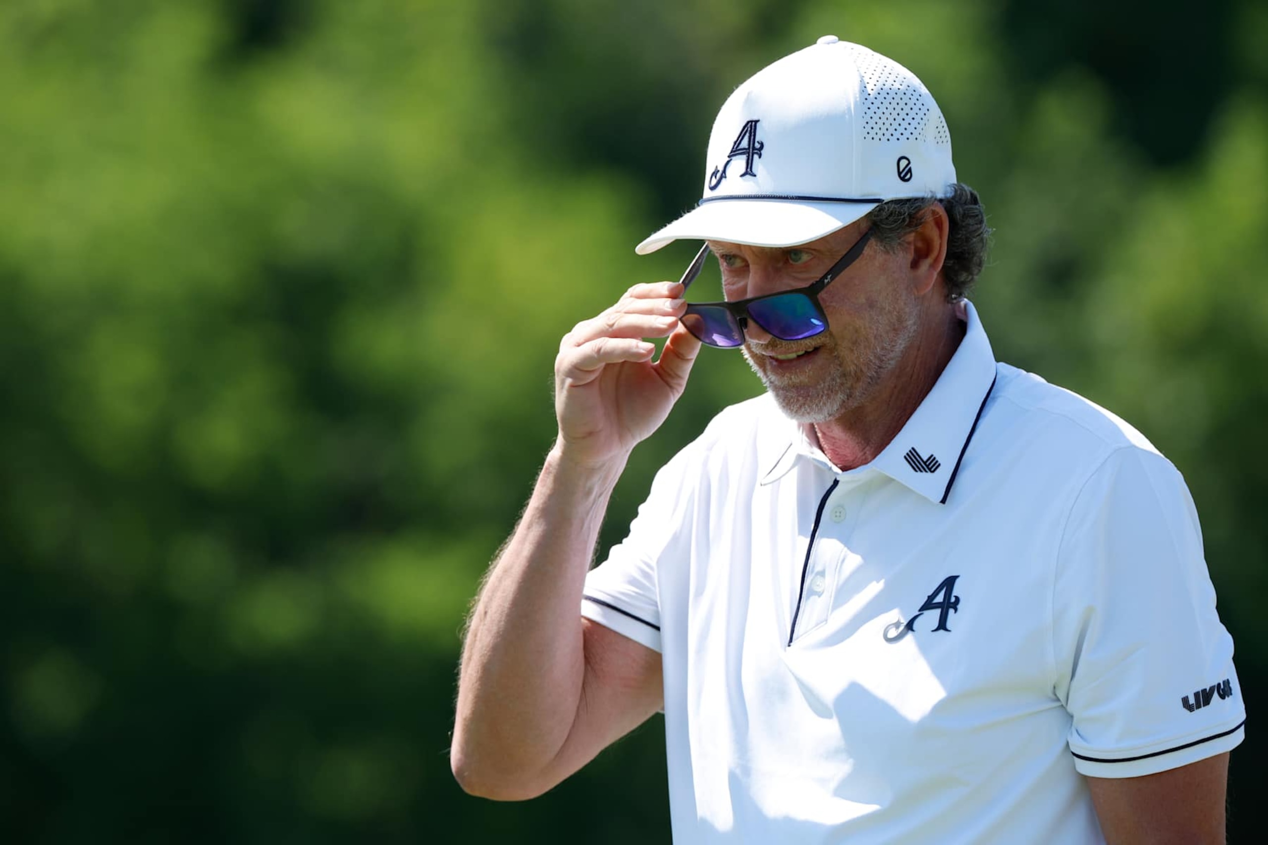 COLLEGE GROVE, TN - JUNE 20: Hockey Hall of Fame member Wayne Gretzky looks over his sunglasses to watch his tee shot during a pro-am practice round during LIV Golf Nashville, June 20, 2024, at The Grove in College Grove, Tennessee.  (Photo by Matthew Maxey/Icon Sportswire via Getty Images)