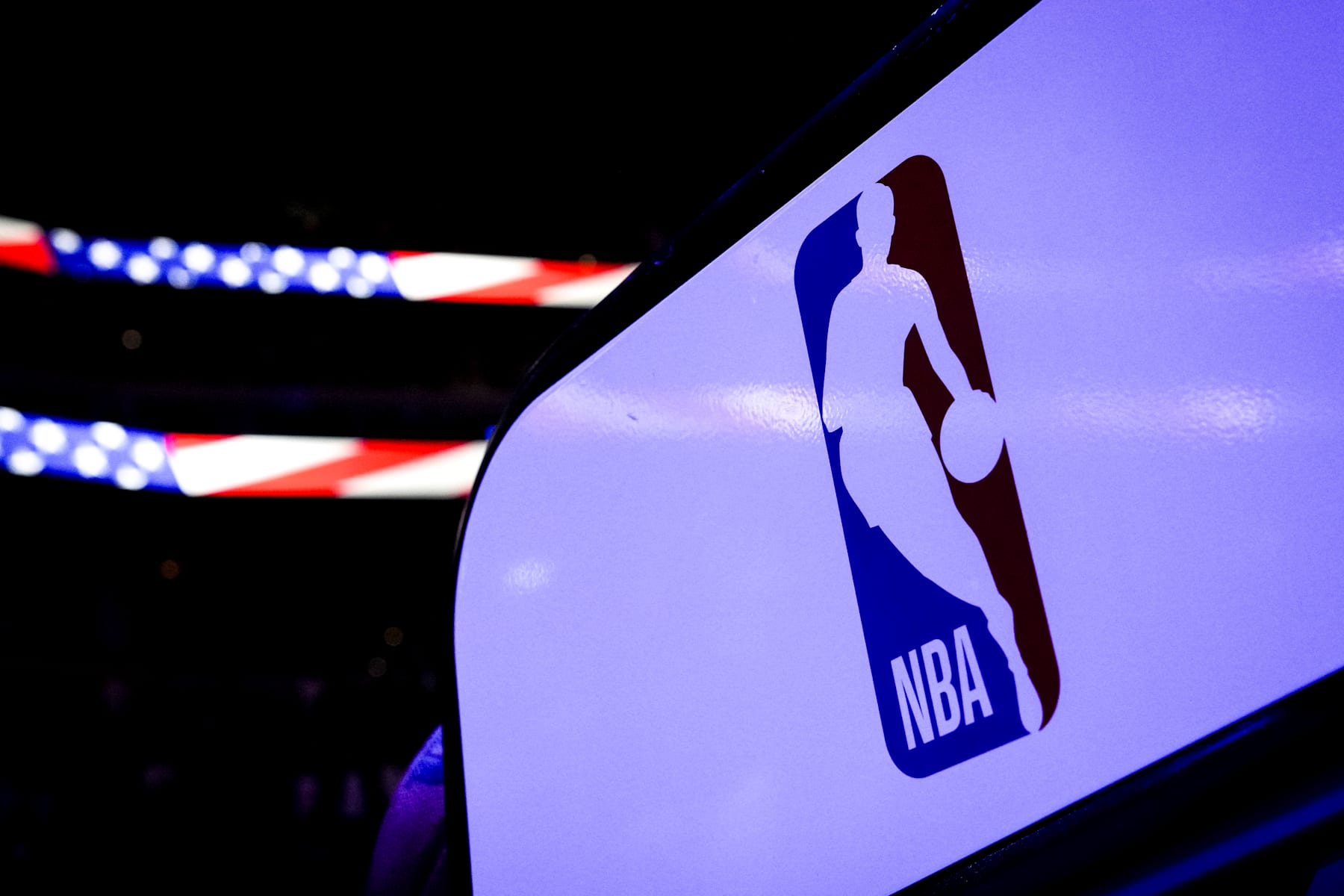 DETROIT, MICHIGAN - NOVEMBER 08: The NBA logo is pictured with an American flag banner in the background before the game between the Detroit Pistons and Atlanta Hawks at Little Caesars Arena on November 08, 2024 in Detroit, Michigan. NOTE TO USER: User expressly acknowledges and agrees that, by downloading and or using this photograph, User is consenting to the terms and conditions of the Getty Images License Agreement. (Photo by Nic Antaya/Getty Images)