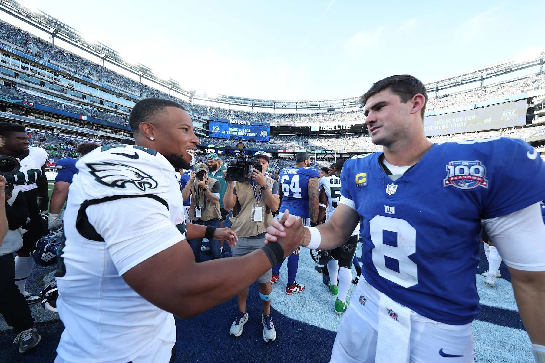 EAST RUTHERFORD, NEW JERSEY - OCTOBER 20: Saquon Barkley #26 of the Philadelphia Eagles shakes hands with Daniel Jones #8 of the New York Giants following the game at MetLife Stadium on October 20, 2024 in East Rutherford, New Jersey. Philadelphia defeated New York 28-3. (Photo by Al Bello/Getty Images)