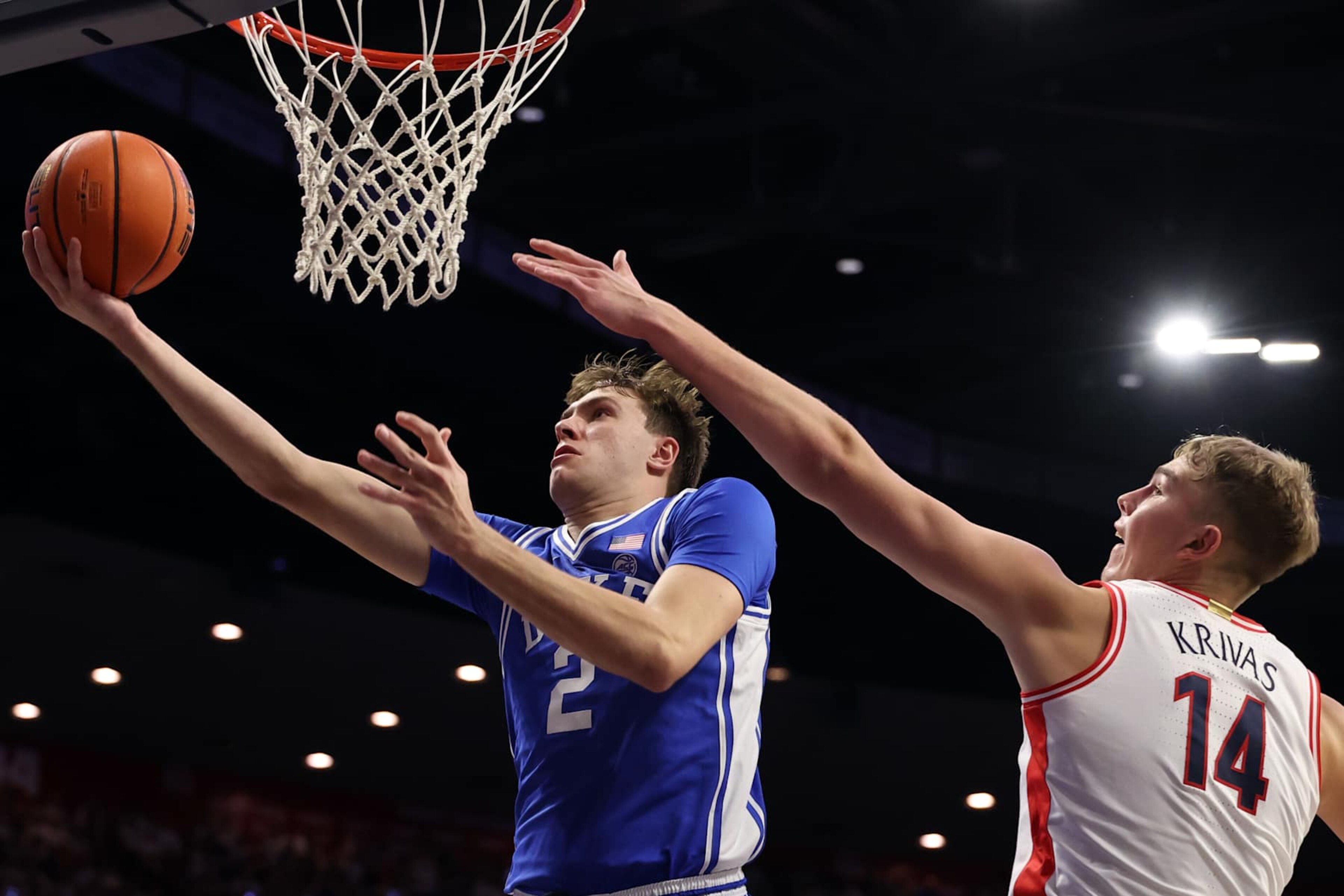 TUCSON, ARIZONA - NOVEMBER 22: Cooper Flagg #2 of the Duke Blue Devils attempts a layup against Motiejus Krivas #14 of the Arizona Wildcats during the second half at McKale Center on November 22, 2024 in Tucson, Arizona. (Photo by Chris Coduto/Getty Images) TUCSON, ARIZONA - NOVEMBER 22: Cooper Flagg #2 of the Duke Blue Devils attempts a layup against Motiejus Krivas #14 of the Arizona Wildcats during the second half at McKale Center on November 22, 2024 in Tucson, Arizona. (Photo by Chris Coduto/Getty Images)