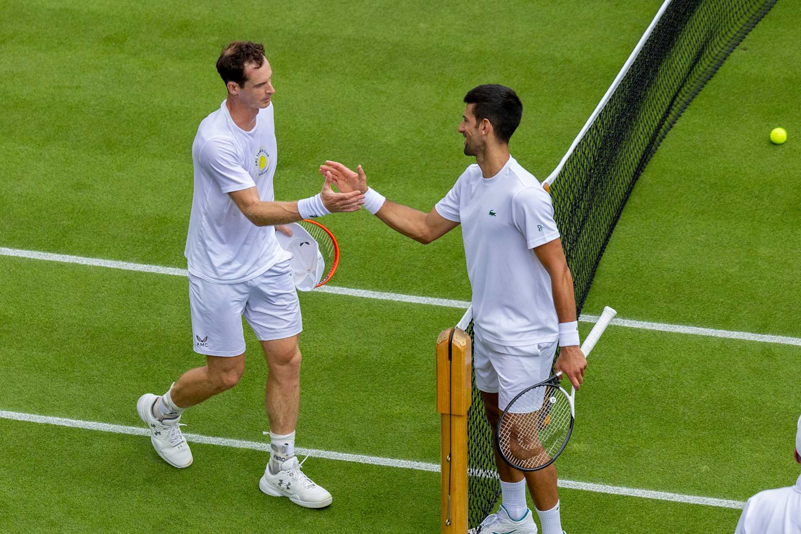 LONDON, ENGLAND - JULY 1.  Novak Djokovic of Serbia and Andy Murray of Great Britain embrace after playing a practice match on Court Fourteen in preparation for the Wimbledon Lawn Tennis Championships at the All England Lawn Tennis and Croquet Club at Wimbledon on July 01, 2023, in London, England. (Photo by Tim Clayton/Corbis via Getty Images)