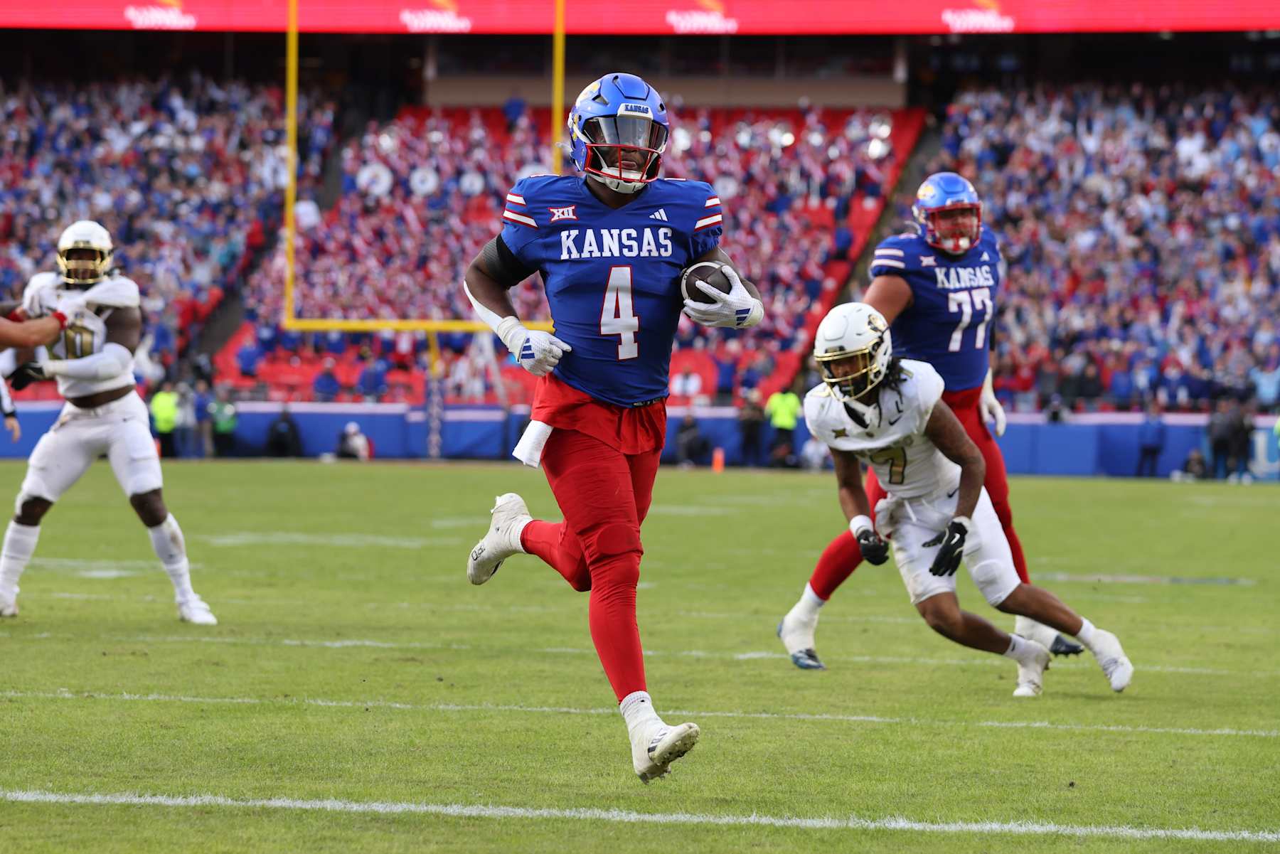 KANSAS CITY, MO - NOVEMBER 23: Kansas Jayhawks running back Devin Neal (4) crosses the goal line for a touchdown in the second quarter of a Big 12 game between the Colorado Buffaloes and Kansas Jayhawks on November 23, 2024 at GEHA Field at Arrowhead Stadium in Kansas City, MO. (Photo by Scott Winters/Icon Sportswire via Getty Images)