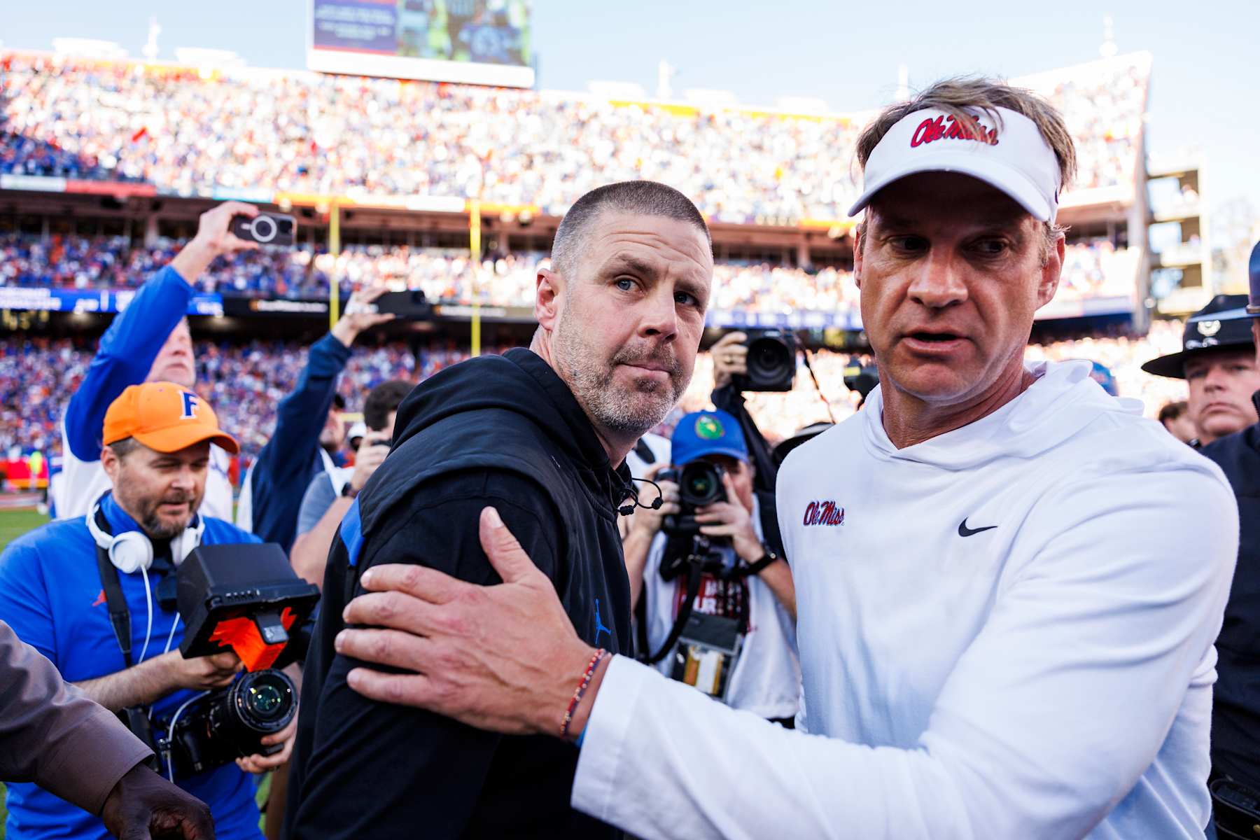 GAINESVILLE, FLORIDA - NOVEMBER 23: Head coach Billy Napier of the Florida Gators (L) right shakes hands with Head coach Lane Kiffin of the Mississippi Rebels (R) after a game at Ben Hill Griffin Stadium on November 23, 2024 in Gainesville, Florida. (Photo by James Gilbert/Getty Images)