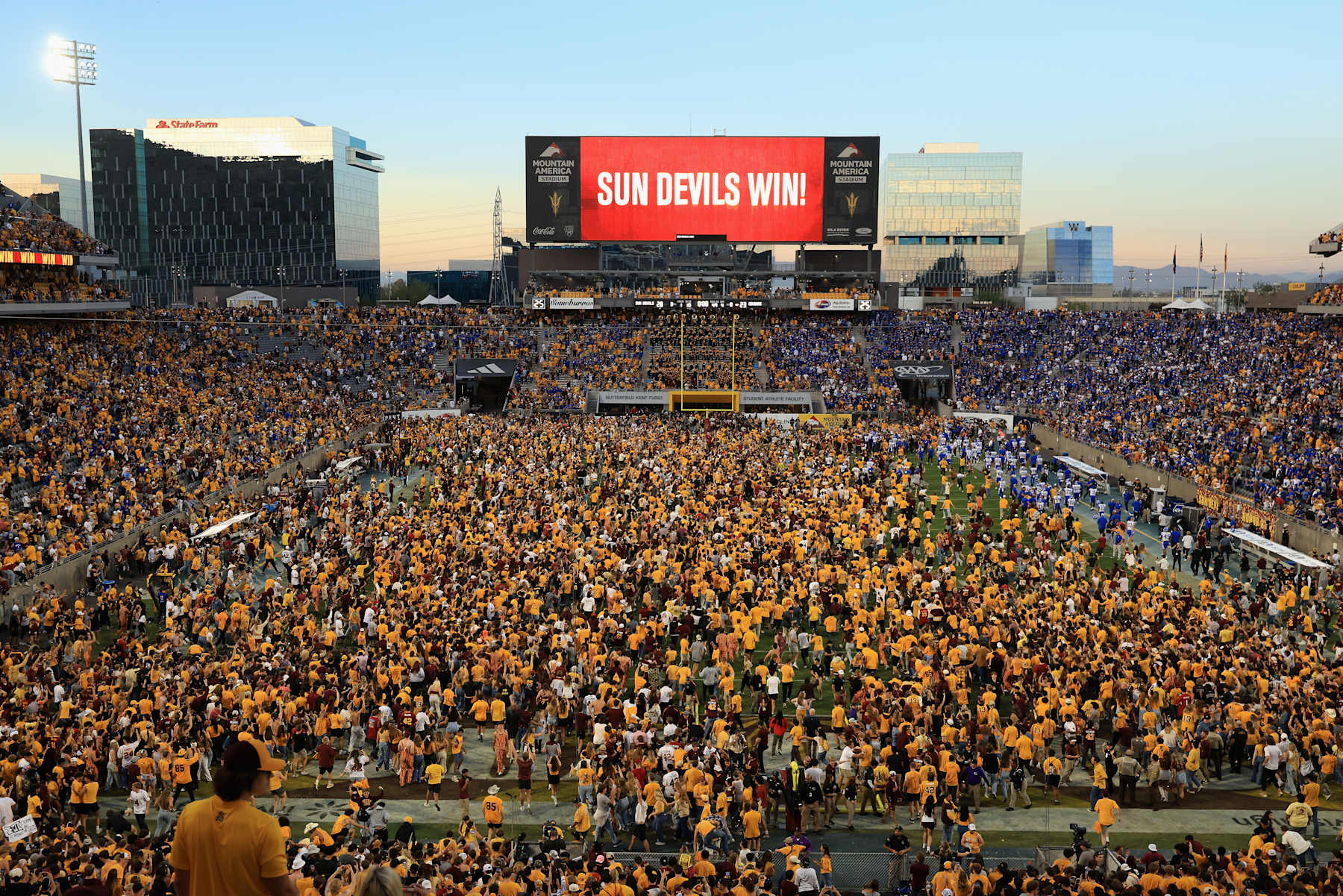 TEMPE, ARIZONA - NOVEMBER 23: Fans rush the field after a resumption of play with 1 second left on the clock during the NCAAF game against the Brigham Young Cougars at Mountain America Stadium on November 23, 2024 in Tempe, Arizona. The Sun Devils defeated the Cougars 28-23. (Photo by Christian Petersen/Getty Images)