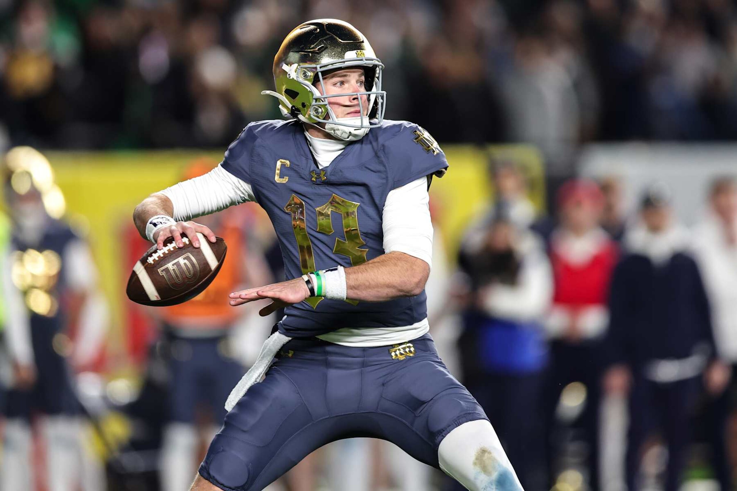 NEW YORK, NEW YORK - NOVEMBER 23: Riley Leonard #13 of the Notre Dame Fighting Irish throws a pass during the second quarter of the game against the Army Black Knights at Yankee Stadium on November 23, 2024 in New York City. (Photo by Dustin Satloff/Getty Images)
