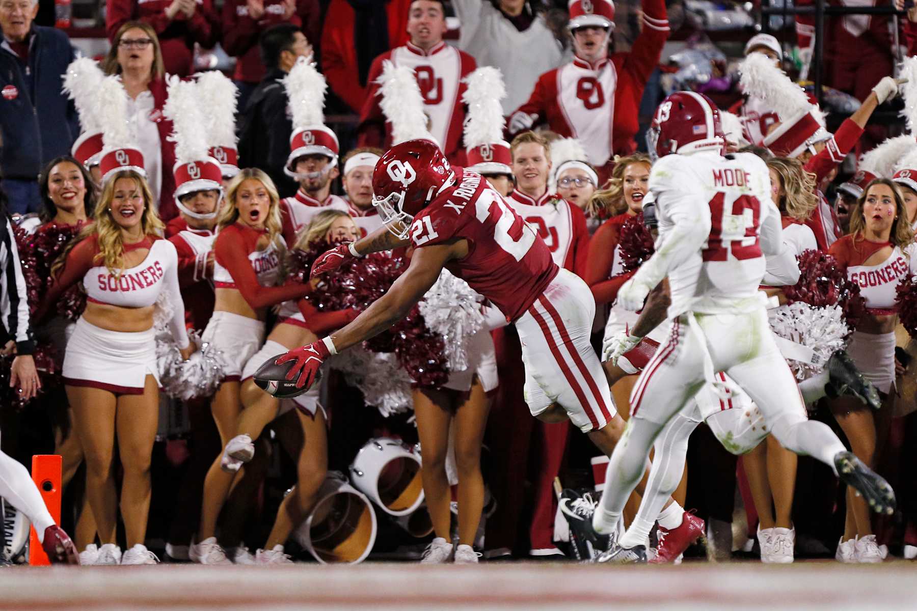 NORMAN, OKLAHOMA - NOVEMBER 23:  Running back Xavier Robinson #21 of the Oklahoma Sooners dives for the end zone to score an 18-yard touchdown against the Alabama Crimson Tide in the second quarter at Gaylord Family Oklahoma Memorial Stadium on November 23, 2024 in Norman, Oklahoma.  (Photo by Brian Bahr/Getty Images)