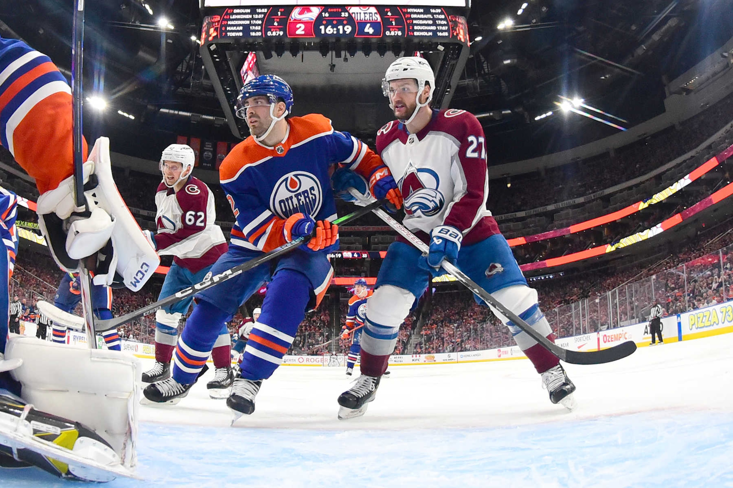 Edmonton Oilers defenseman Evan Bouchard (left) and Colorado Avalanche winger Jonathan Drouin. 