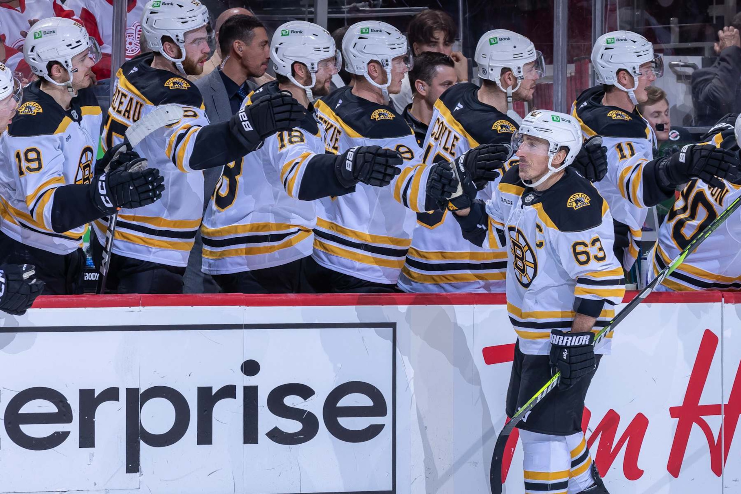 DETROIT, MICHIGAN-NOVEMBER 23: Brad Marchand #63 of the Boston Bruins celebrates his goal with teammates on the bench during the third period at Little Caesars Arena on November 23, 2024 in Detroit, Michigan. Boston defeated  Detroit 2-1. (Photo by Dave Reginek/NHLI via Getty Images)