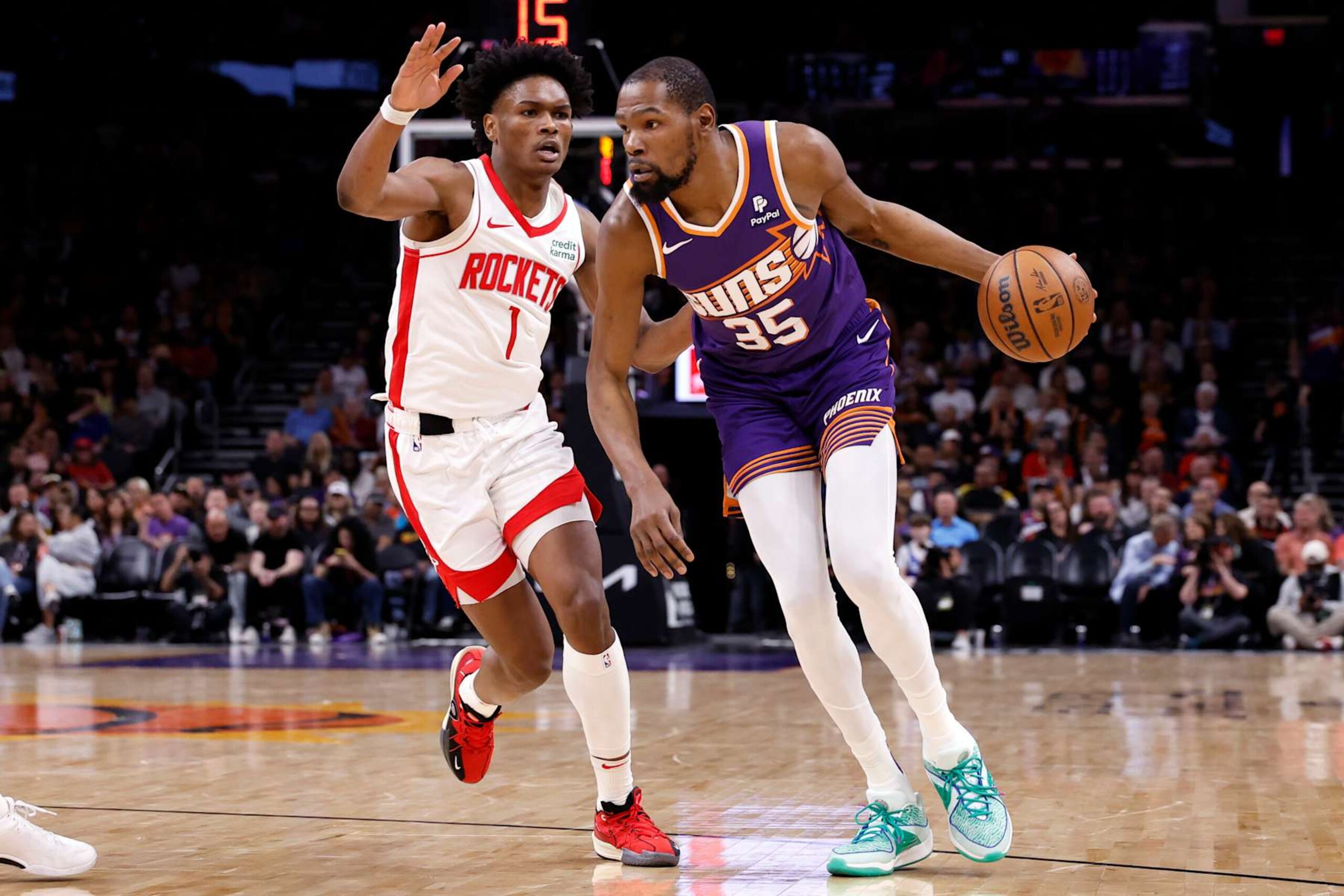 PHOENIX, ARIZONA - MARCH 02: Kevin Durant #35 of the Phoenix Suns drives against Amen Thompson #1 of the Houston Rockets during the game at Footprint Center on March 02, 2024 in Phoenix, Arizona. The Rockets defeated the Suns 118-109. NOTE TO USER: User expressly acknowledges and agrees that, by downloading and or using this photograph, User is consenting to the terms and conditions of the Getty Images License Agreement.  (Photo by Chris Coduto/Getty Images)
