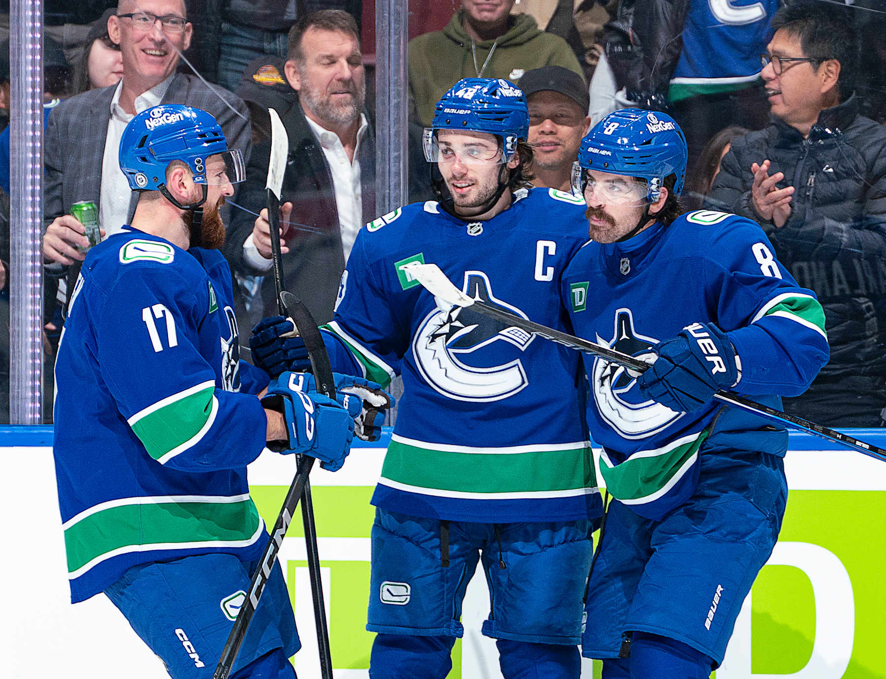 VANCOUVER, CANADA - NOVEMBER 19: Conor Garland #8 celebrates with Quinn Hughes #43 and Filip Hronek #17 of the Vancouver Canucks after scoring a goal in the second period during their NHL game against the New York Rangers at Rogers Arena on November 19, 2024 in Vancouver, British Columbia, Canada.  (Photo by Jeff Vinnick/NHLI via Getty Images)