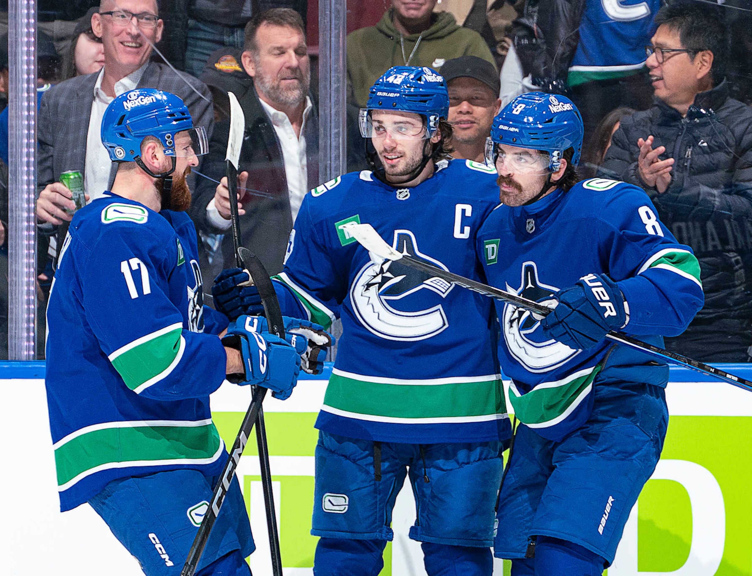 VANCOUVER, CANADA - NOVEMBER 19: Conor Garland #8 celebrates with Quinn Hughes #43 and Filip Hronek #17 of the Vancouver Canucks after scoring a goal in the second period during their NHL game against the New York Rangers at Rogers Arena on November 19, 2024 in Vancouver, British Columbia, Canada.  (Photo by Jeff Vinnick/NHLI via Getty Images)