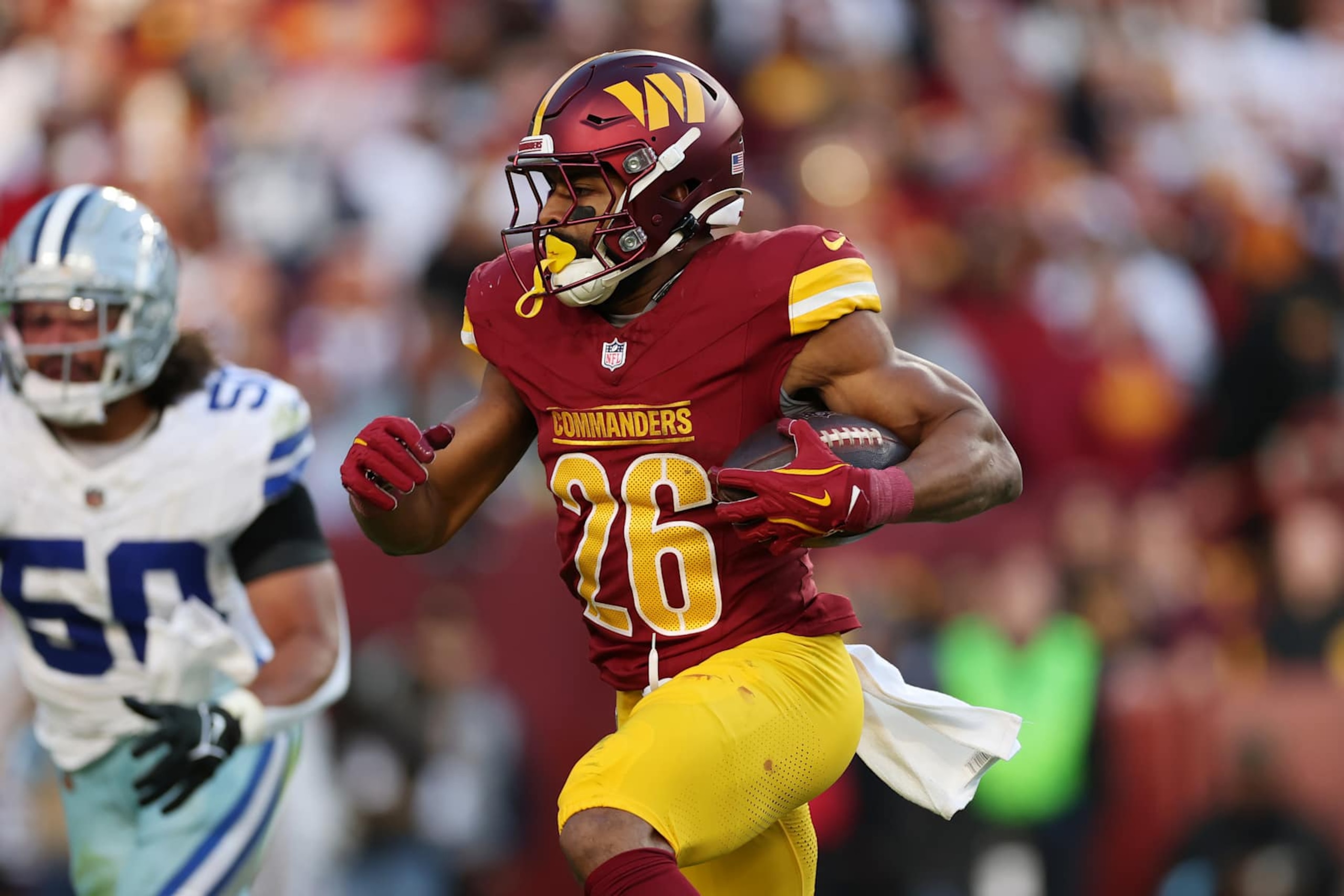 LANDOVER, MARYLAND - NOVEMBER 24: Jeremy McNichols #26 of the Washington Commanders runs with the ball against the Dallas Cowboys during the fourth quarter at Northwest Stadium on November 24, 2024 in Landover, Maryland. (Photo by Patrick Smith/Getty Images)