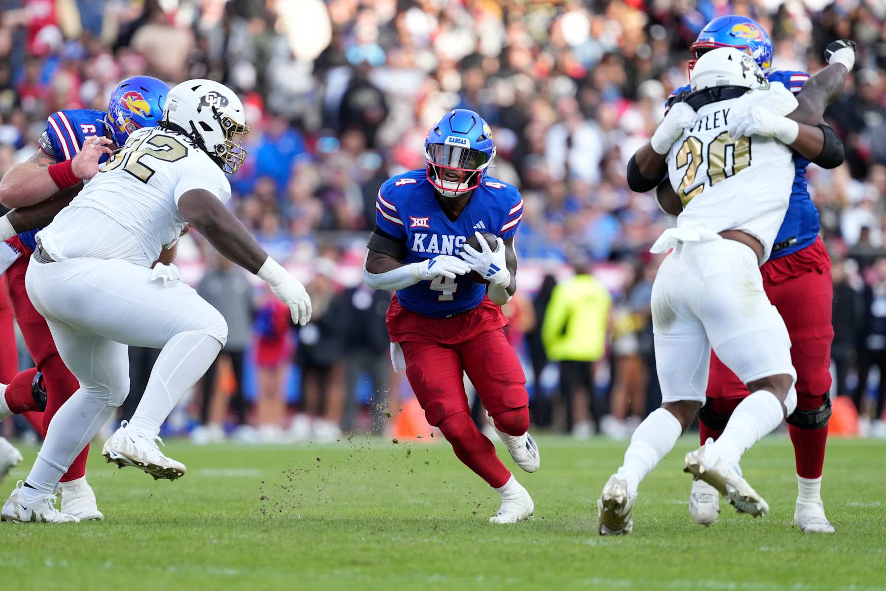 KANSAS CITY, MISSOURI - NOVEMBER 23: Running back Devin Neal #4 of the Kansas Jayhawks runs against the Colorado Buffaloes in the first half at Arrowhead Stadium on November 23, 2024 in Kansas City, Missouri.  (Photo by Ed Zurga/Getty Images)